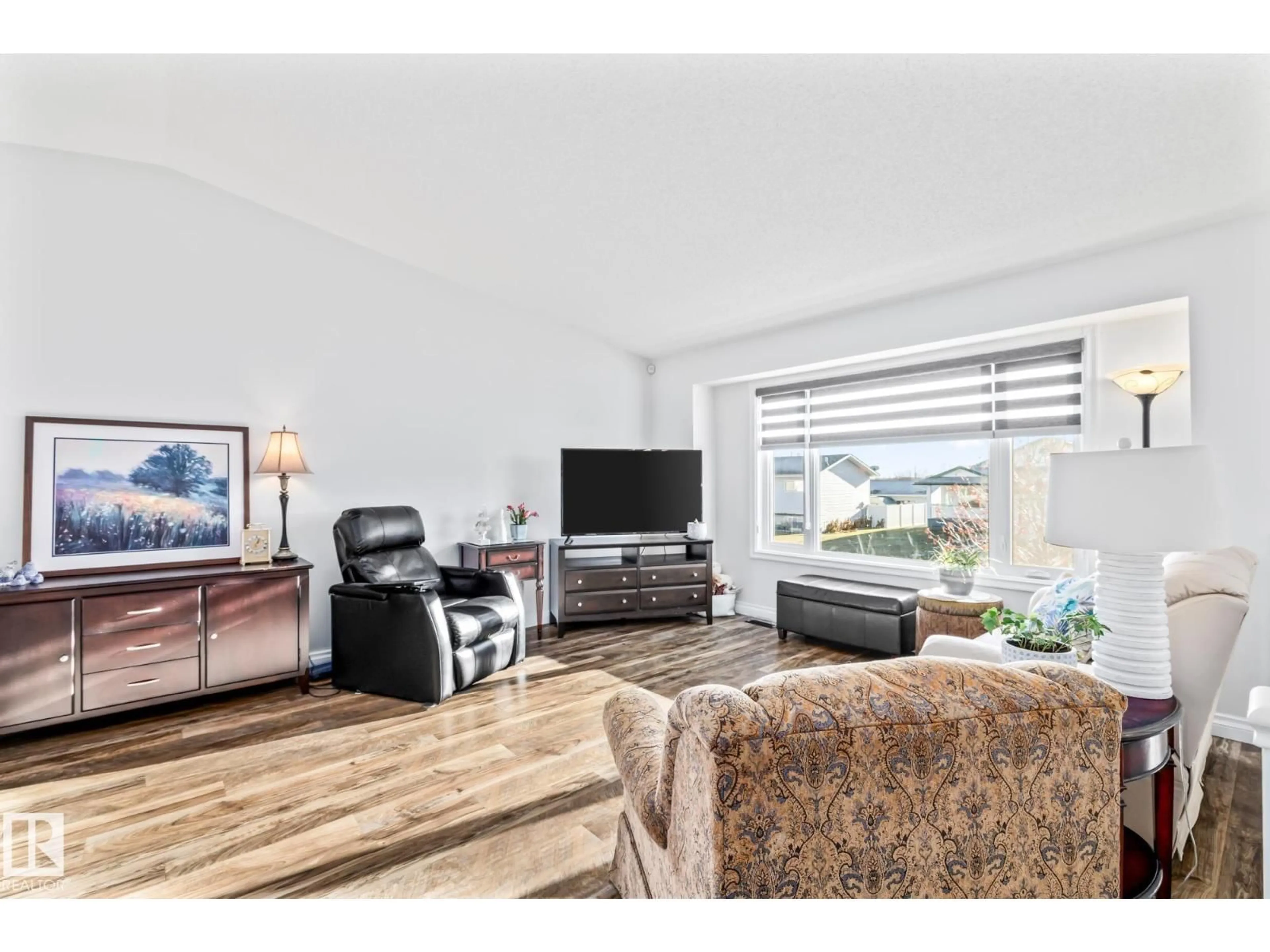 Living room with furniture, wood/laminate floor for 4701 49 ST, Legal Alberta T0G1L0