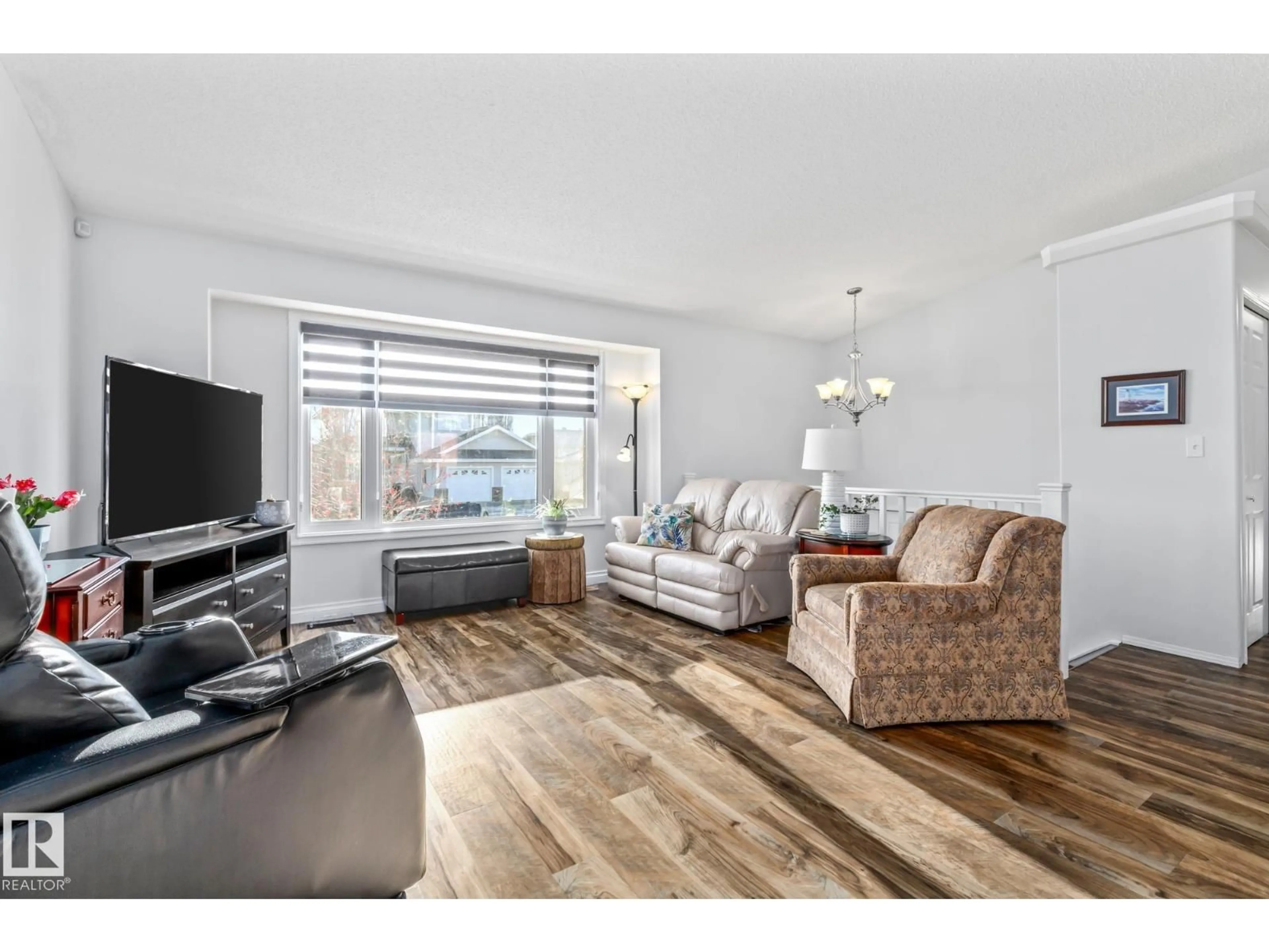 Living room with furniture, wood/laminate floor for 4701 49 ST, Legal Alberta T0G1L0