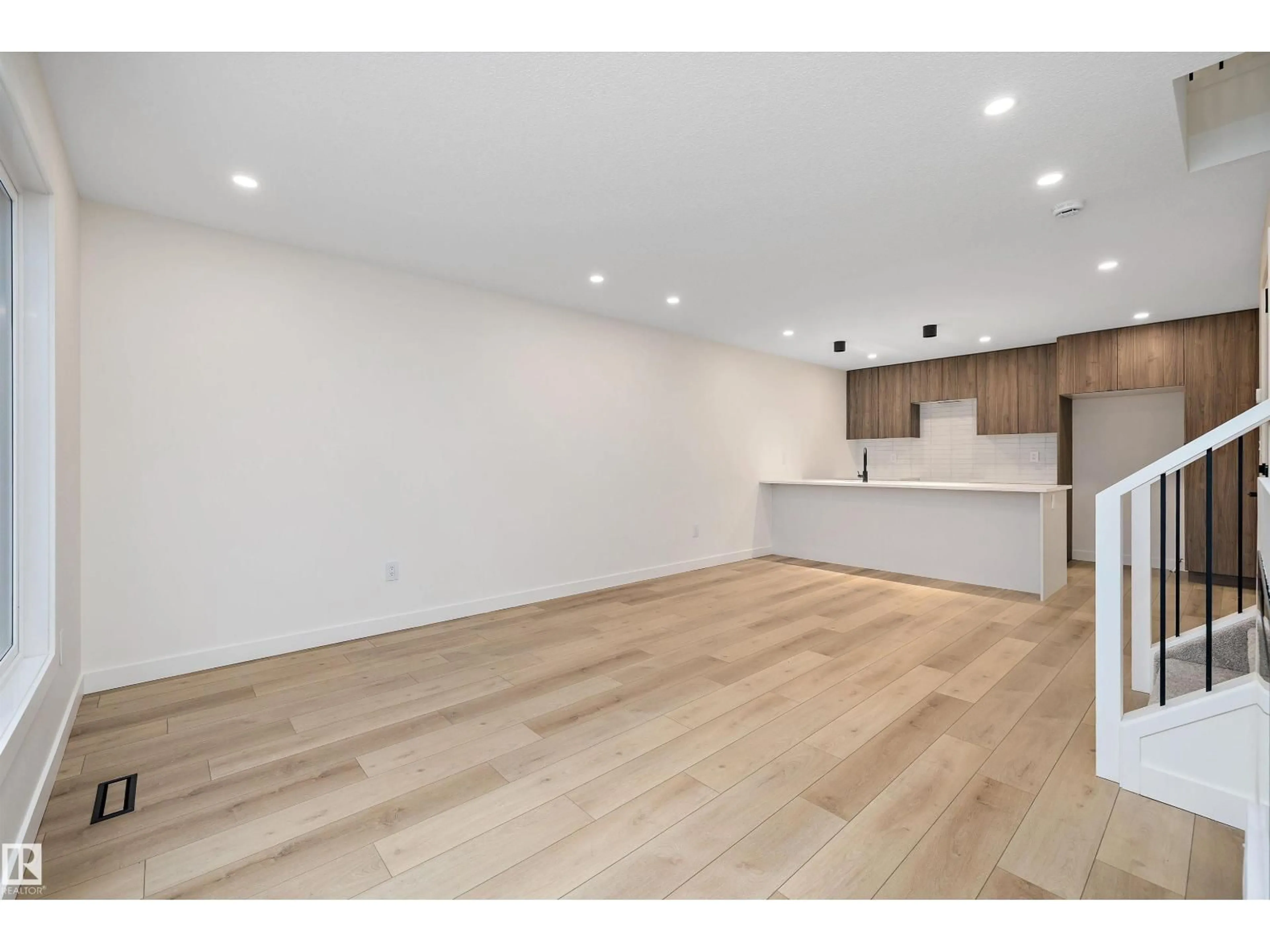 Open concept kitchen, wood/laminate floor for 11605 90 ST, Edmonton Alberta T5B3T6