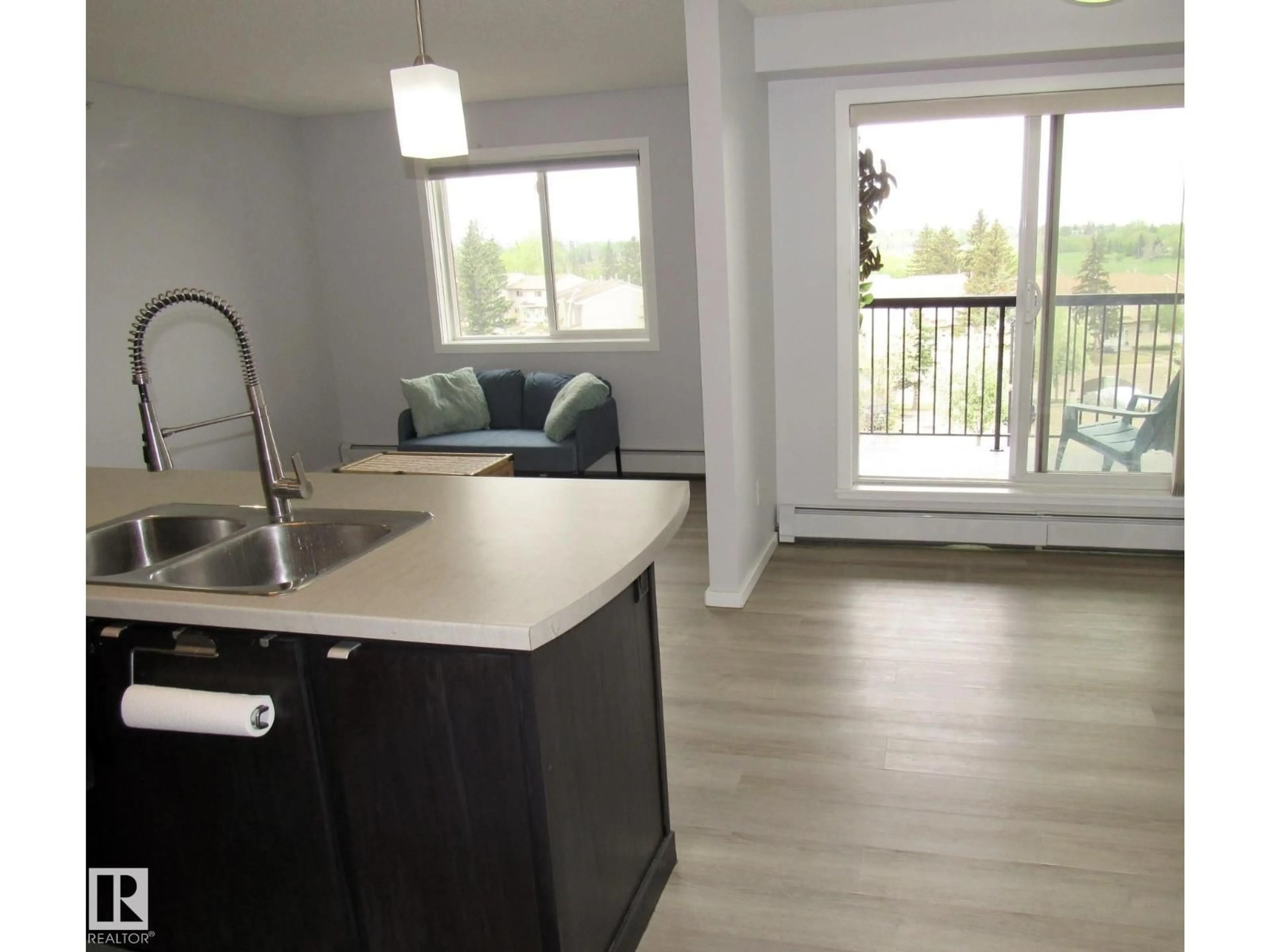 Open concept kitchen, wood/laminate floor for #453 - 1196 HYNDMAN RD, Edmonton Alberta T5A0X8