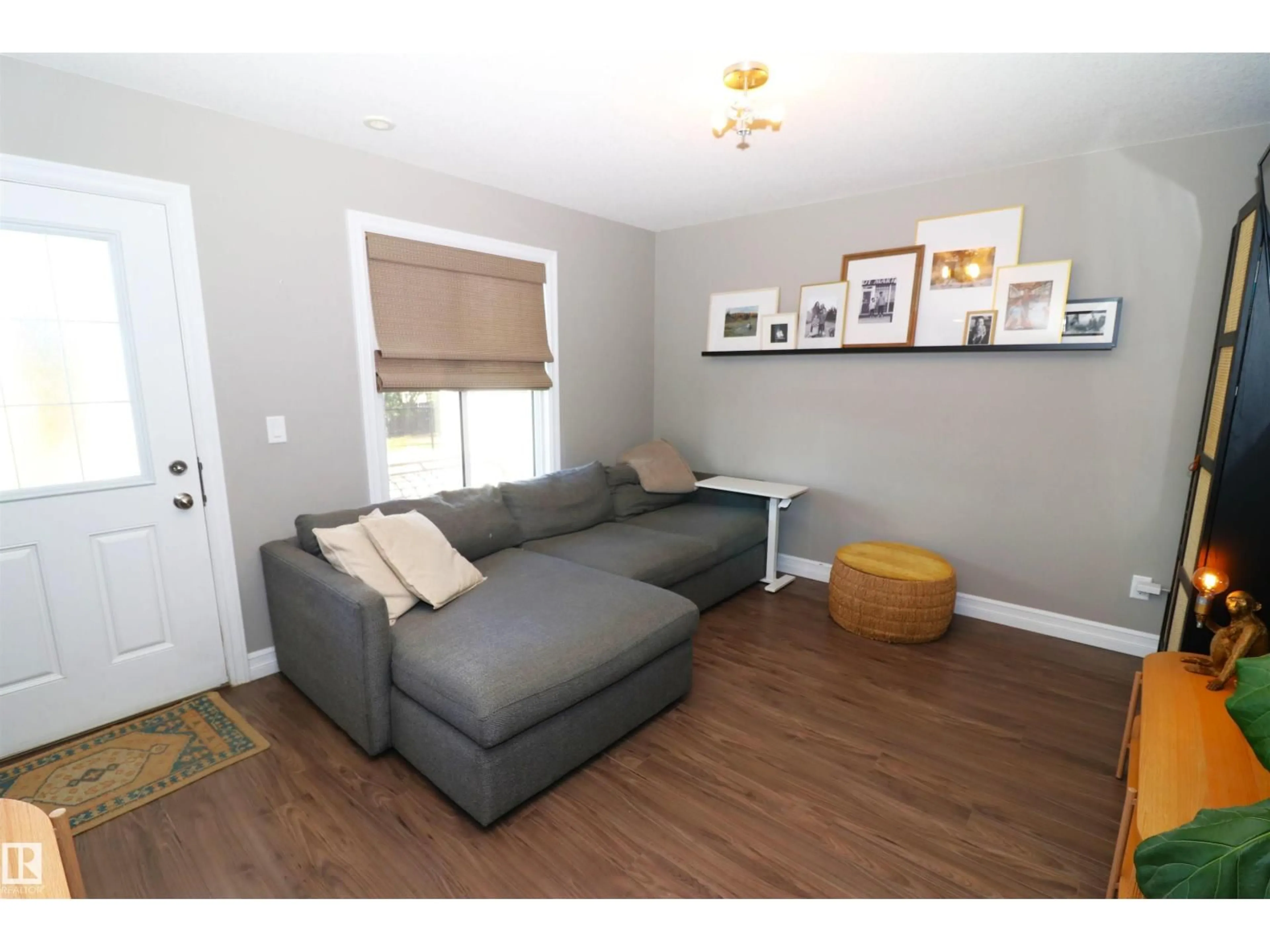 Living room with furniture, wood/laminate floor for 1508 105 ST, Edmonton Alberta T6J5R8