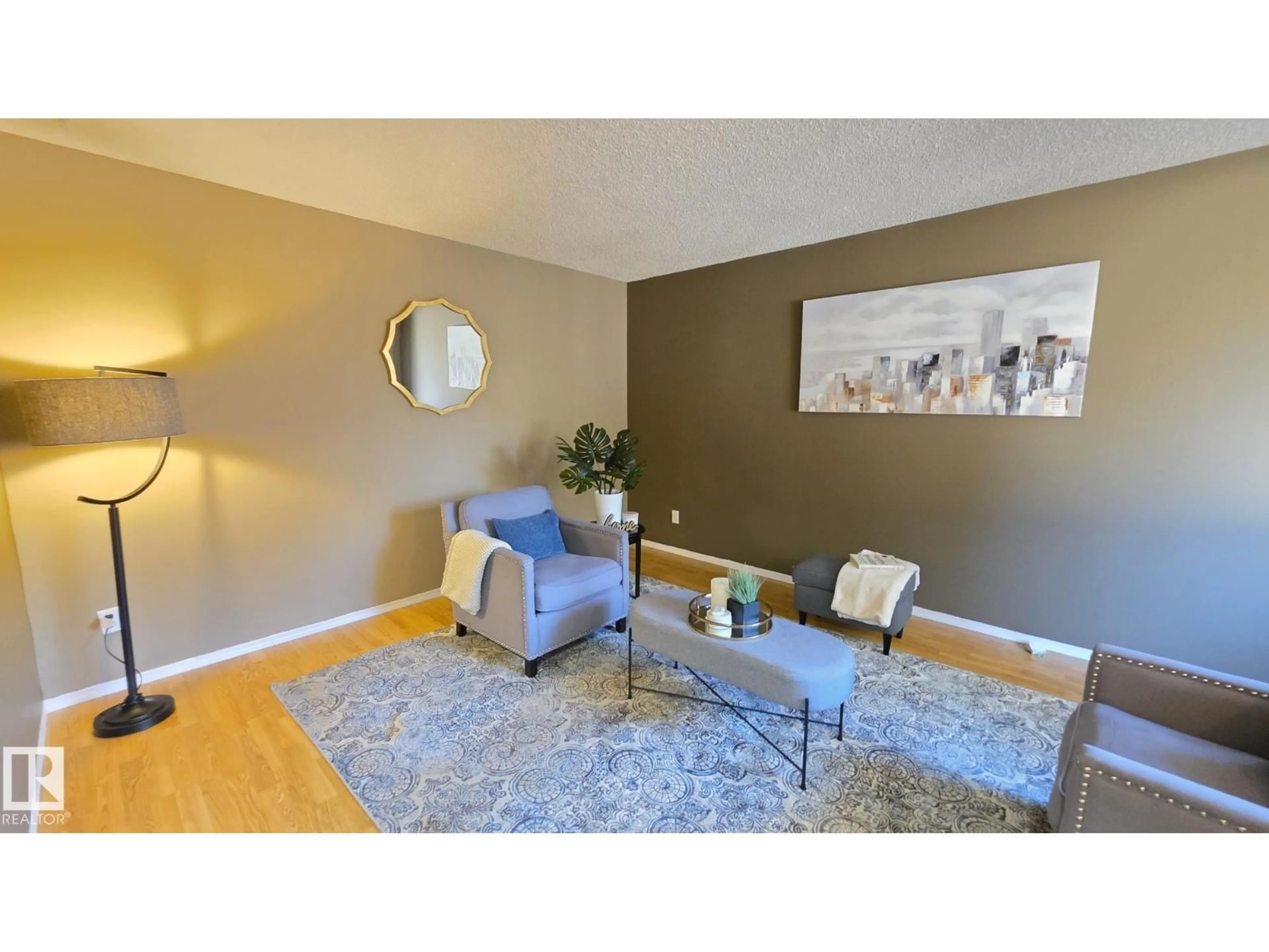 Living room with furniture, wood/laminate floor for 117 LONDONDERRY SQ, Edmonton Alberta T5C3C4