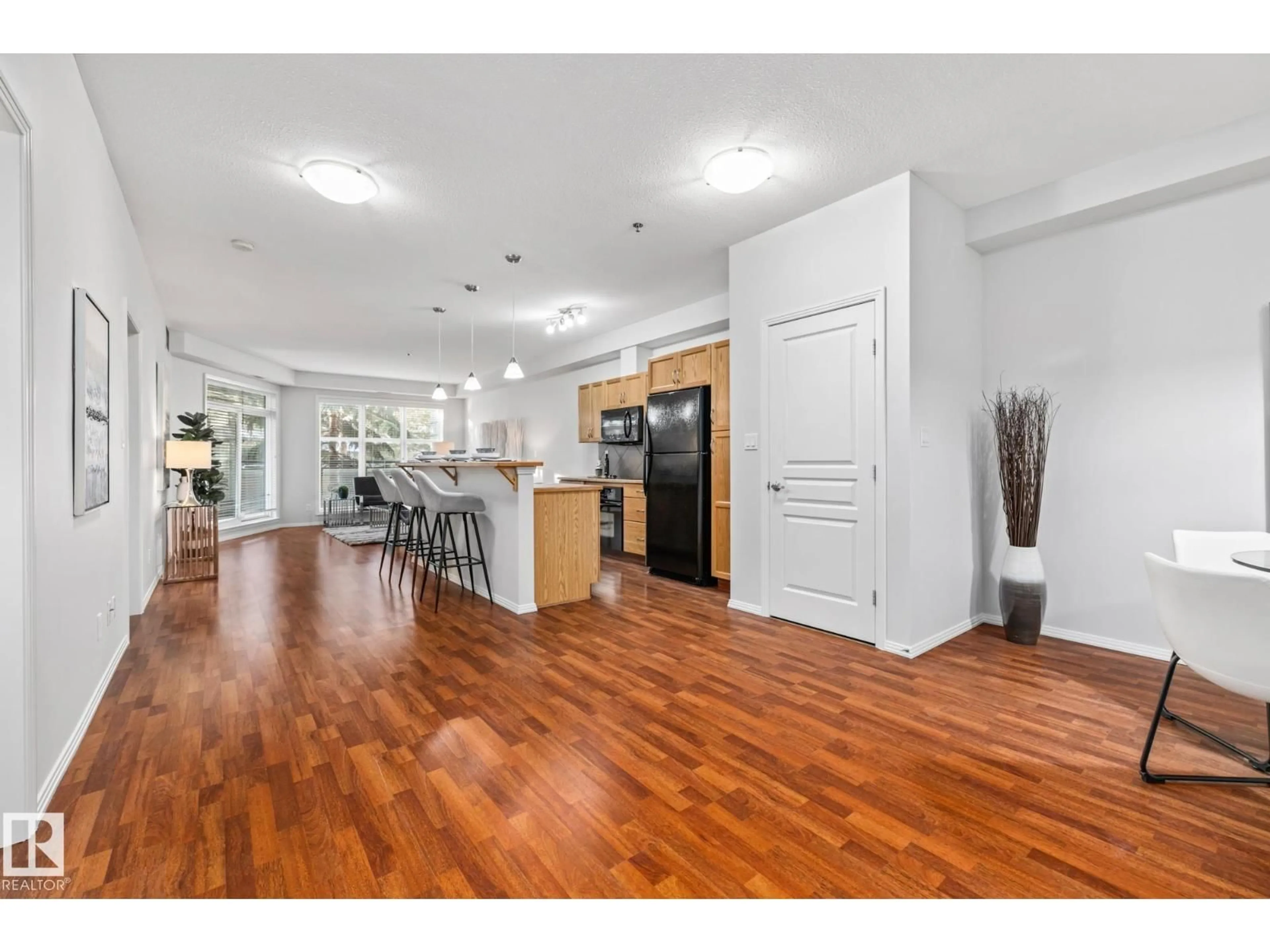 Open concept kitchen, wood/laminate floor for #127 - 4831 104A ST, Edmonton Alberta T6H0R5