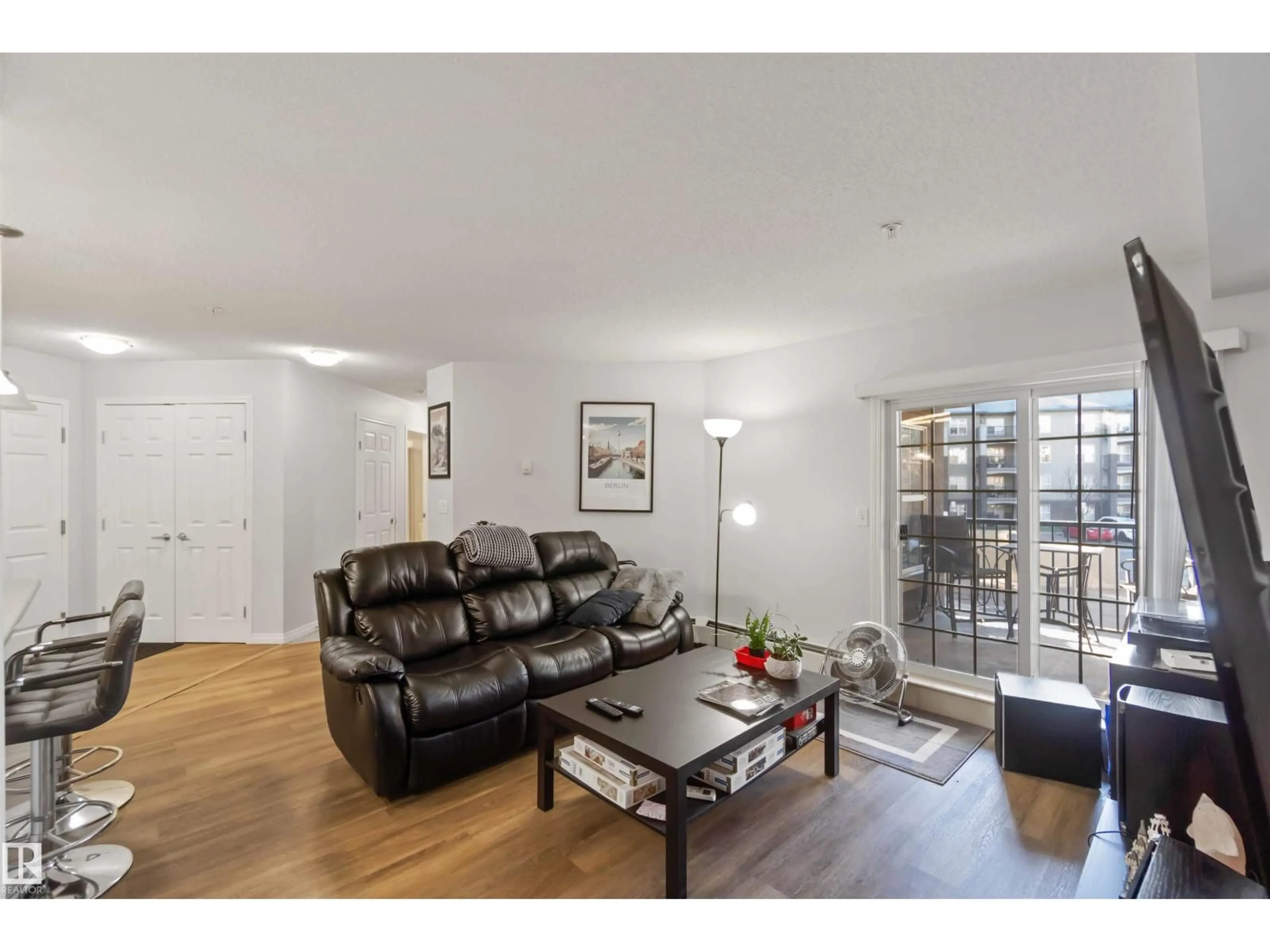 Living room with furniture, wood/laminate floor for 203 - 636 MCALLISTER LO, Edmonton Alberta T6W1N4