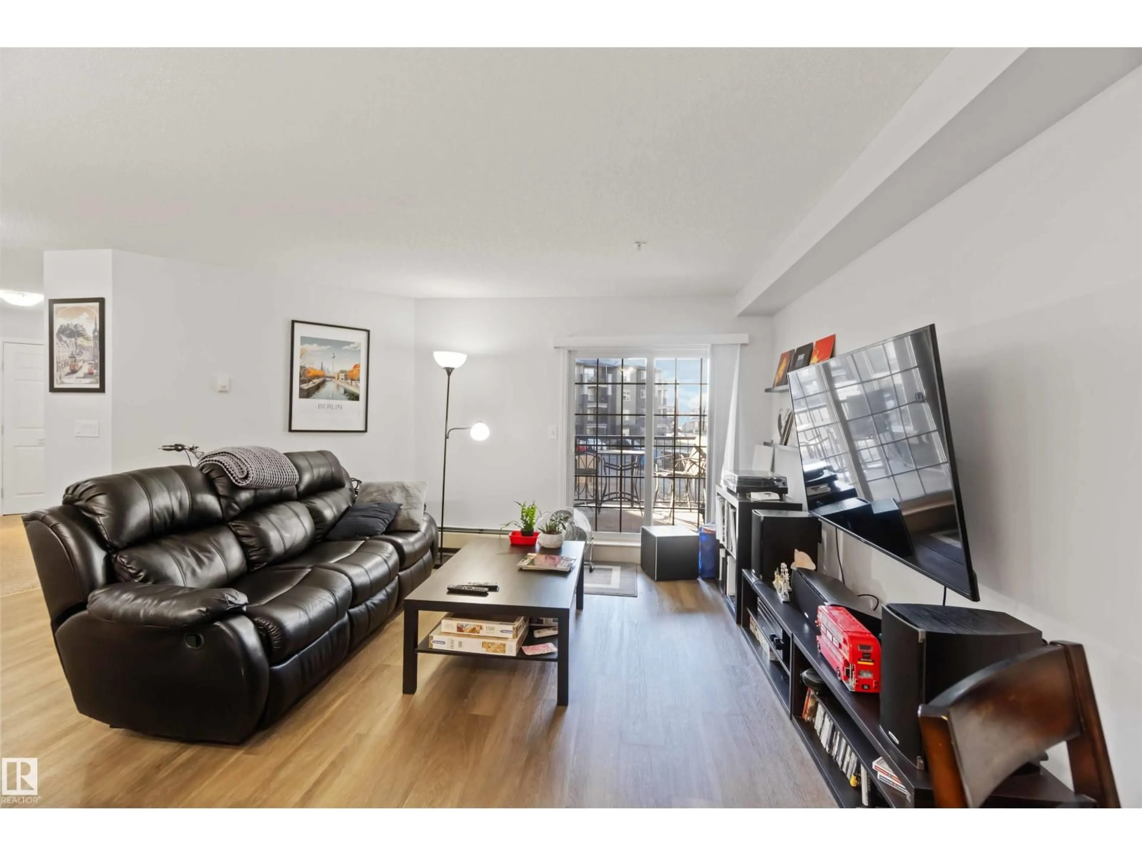 Living room with furniture, wood/laminate floor for 203 - 636 MCALLISTER LO, Edmonton Alberta T6W1N4
