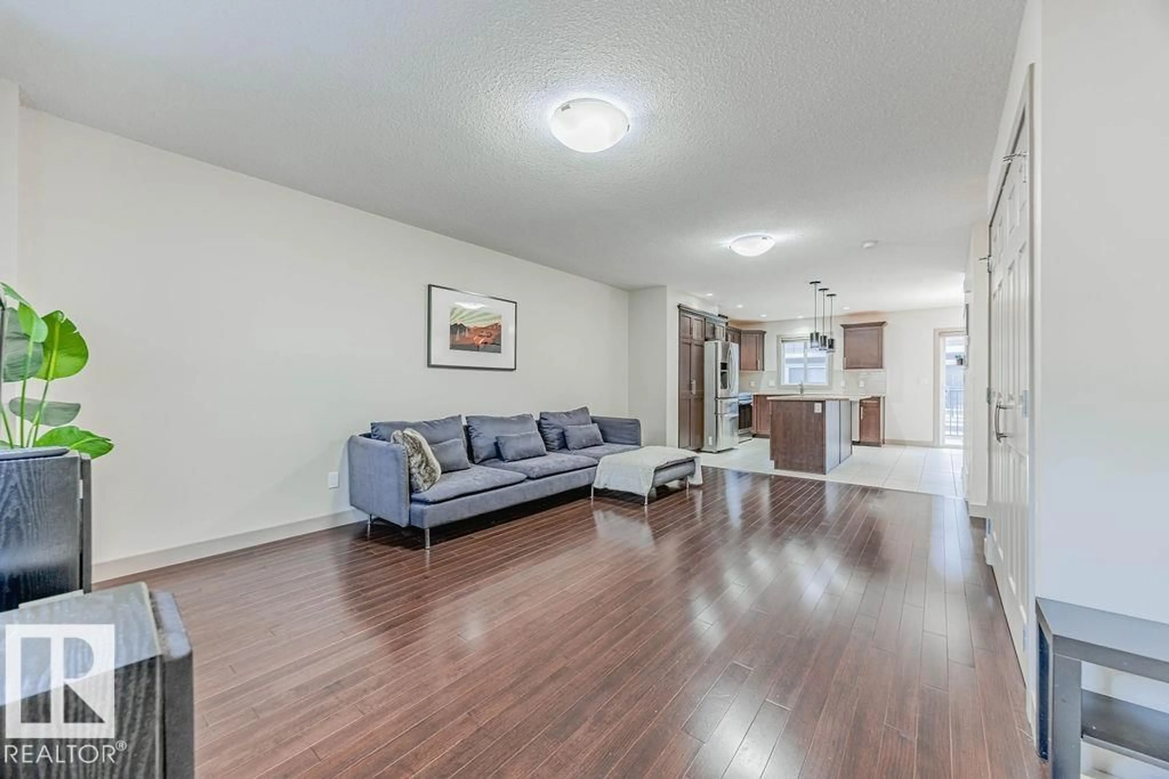 Living room with furniture, wood/laminate floor for 1150 - 16 WINDERMERE WY, Edmonton Alberta T6W2B6