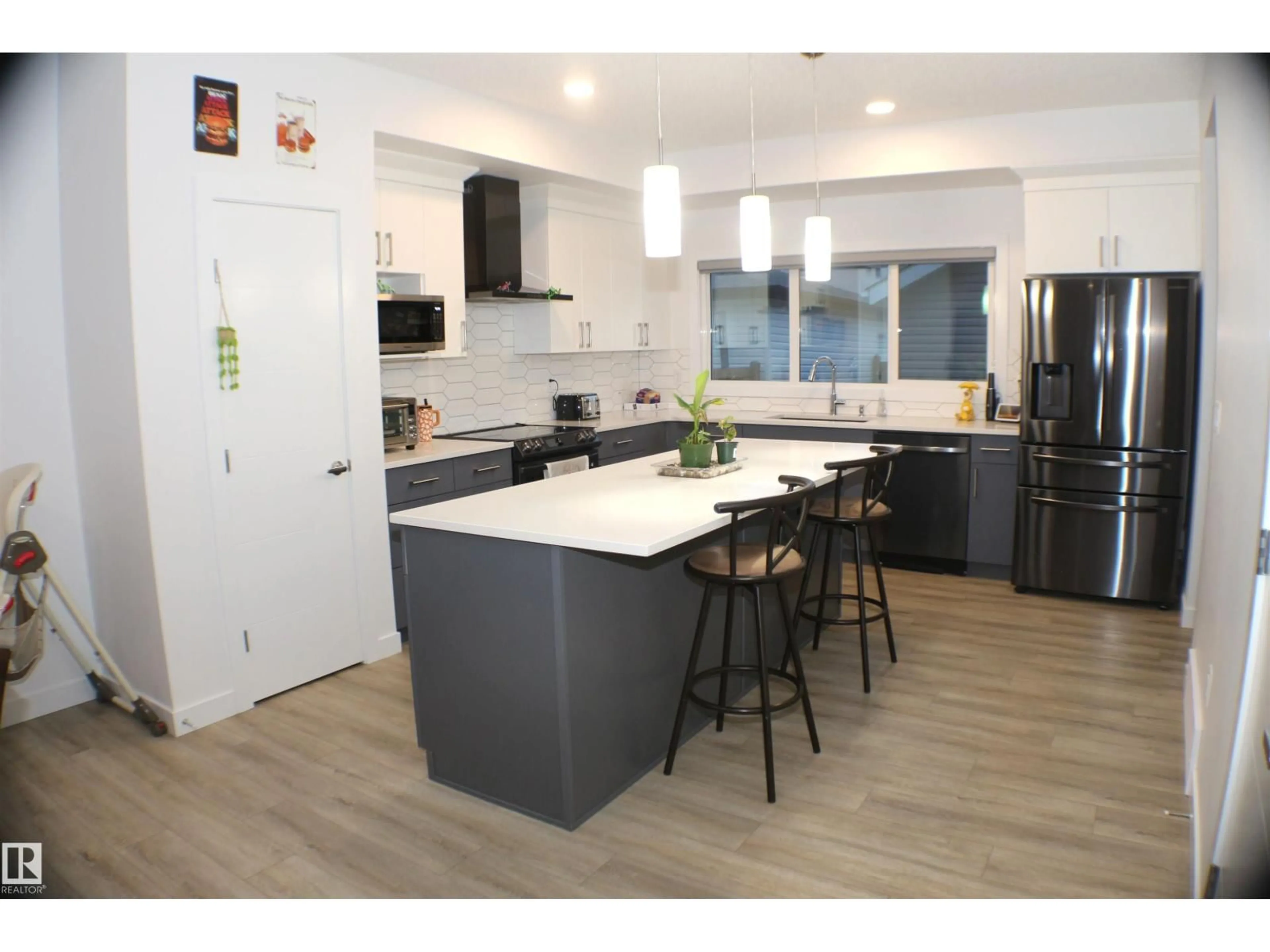 Open concept kitchen, wood/laminate floor for 621 BLACK STONE BV, Leduc Alberta T9E1M3