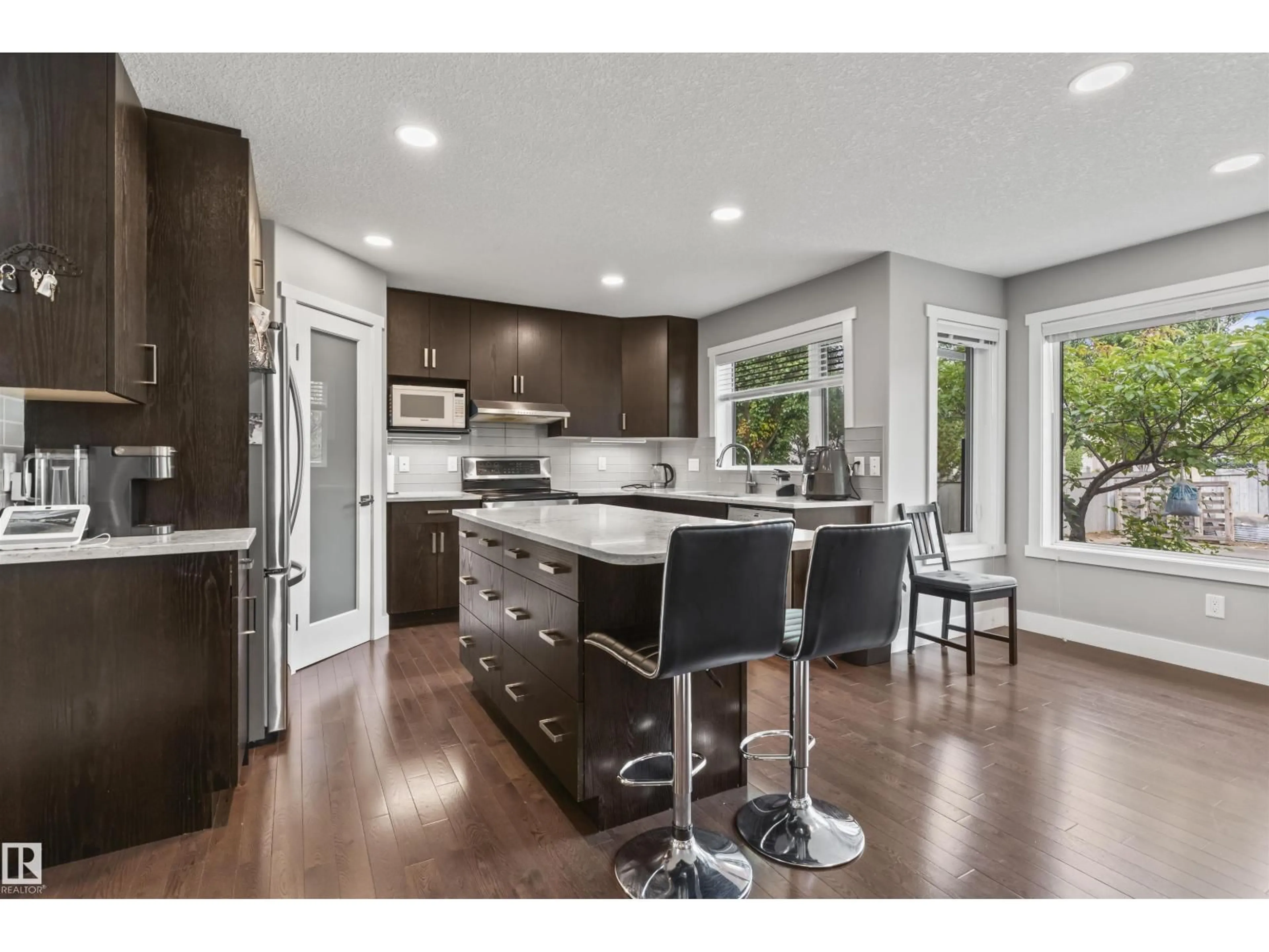 Open concept kitchen, wood/laminate floor for 3747 30 ST, Edmonton Alberta T6T1H7