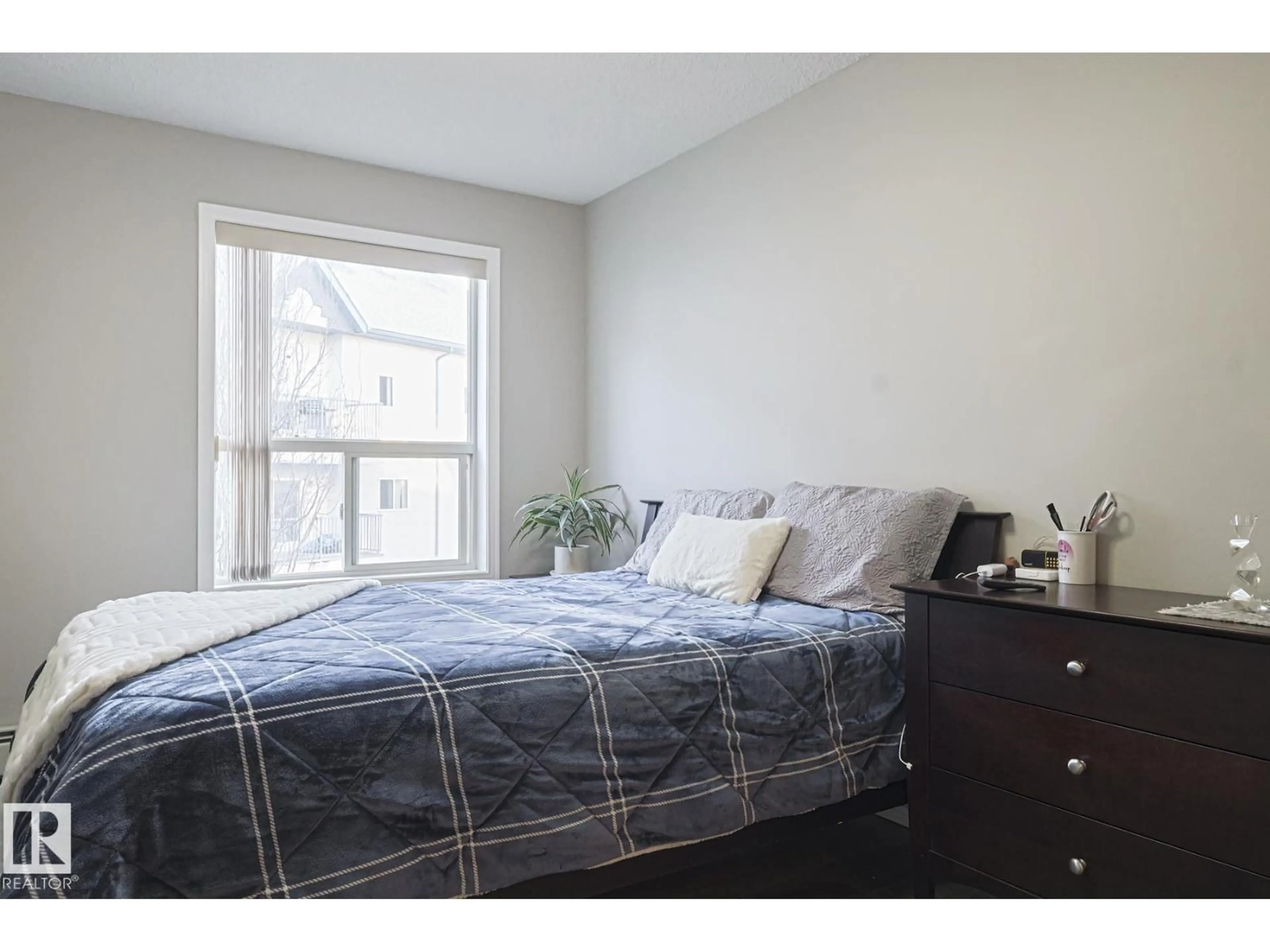 Bedroom with bed, wood/laminate floor for 317 - 9730 174 ST NW, Edmonton Alberta T5T6J4