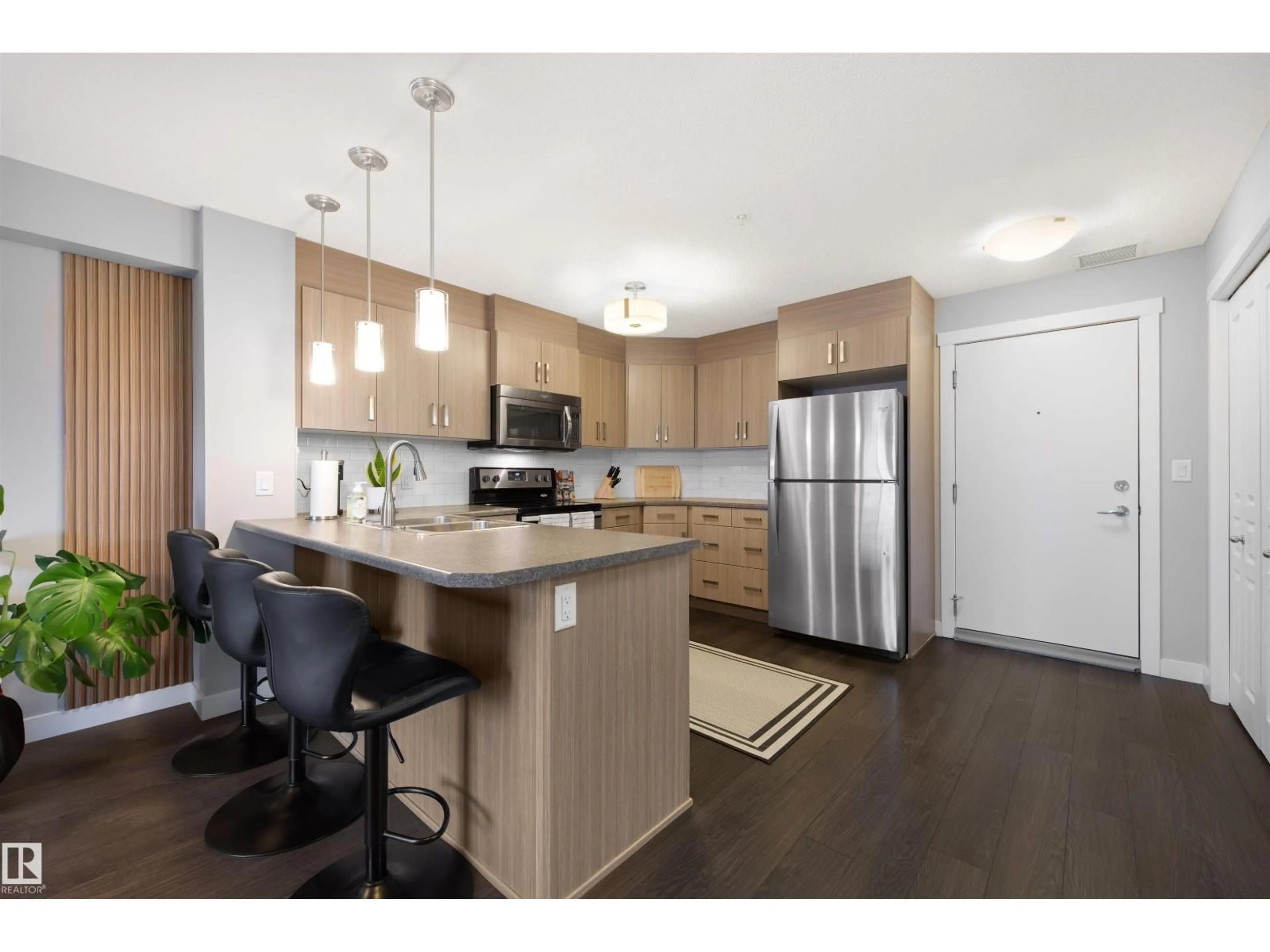 Open concept kitchen, wood/laminate floor for #313 - 2229 44 AV NW, Edmonton Alberta T6T0W6