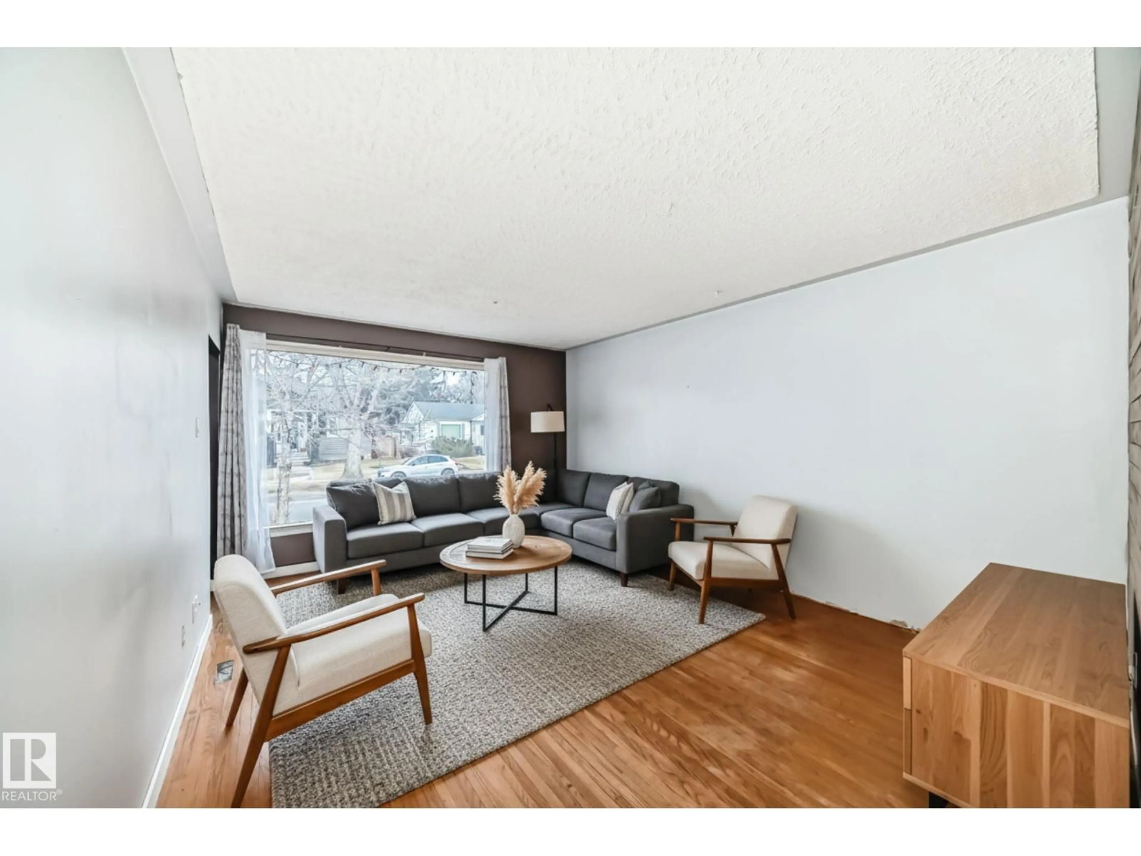 Living room with furniture, wood/laminate floor for 4037 114 AV, Edmonton Alberta T5W0S9