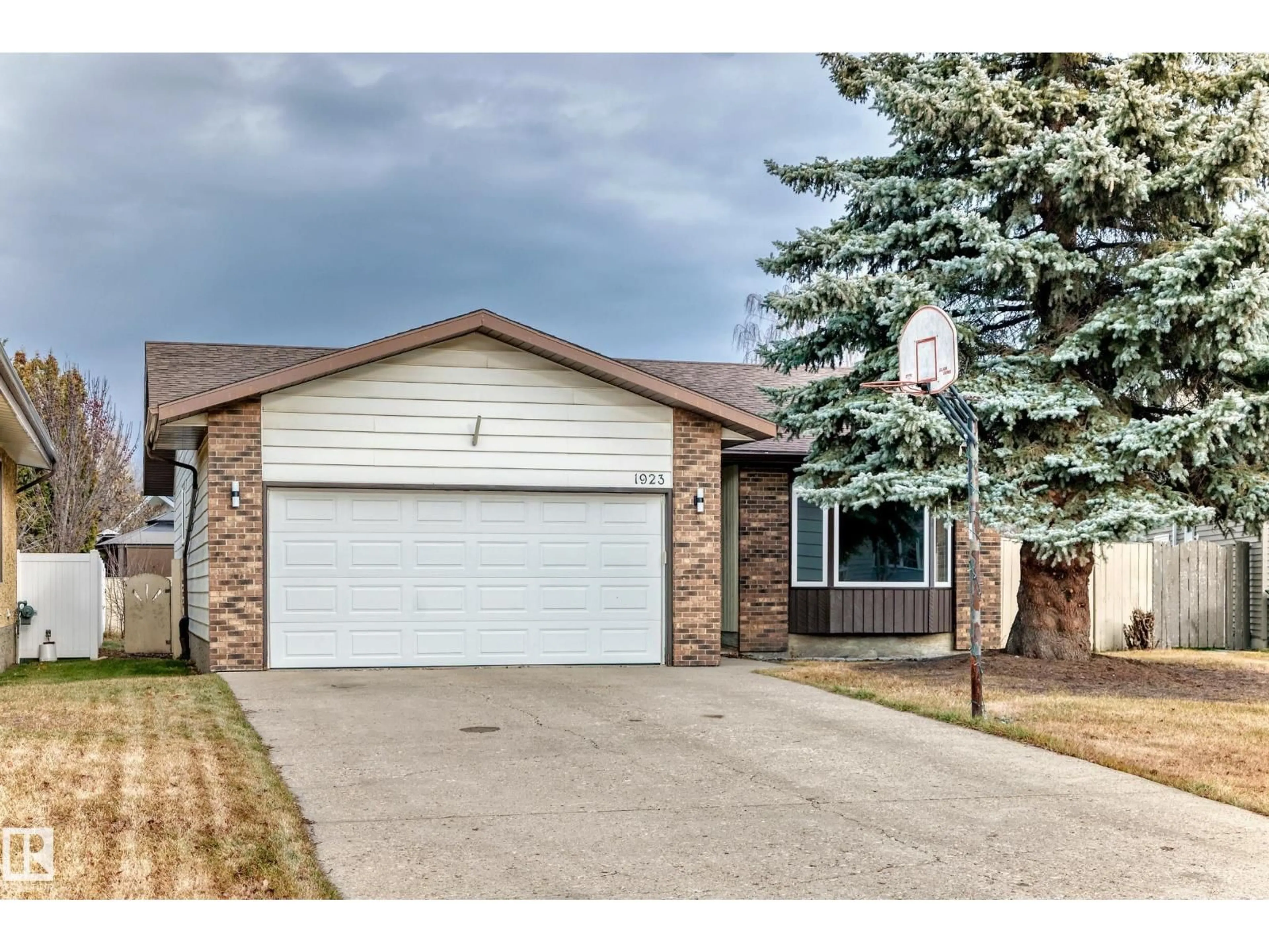 Home with brick exterior material, street for NW - 1923 52 ST, Edmonton Alberta T6L1J3