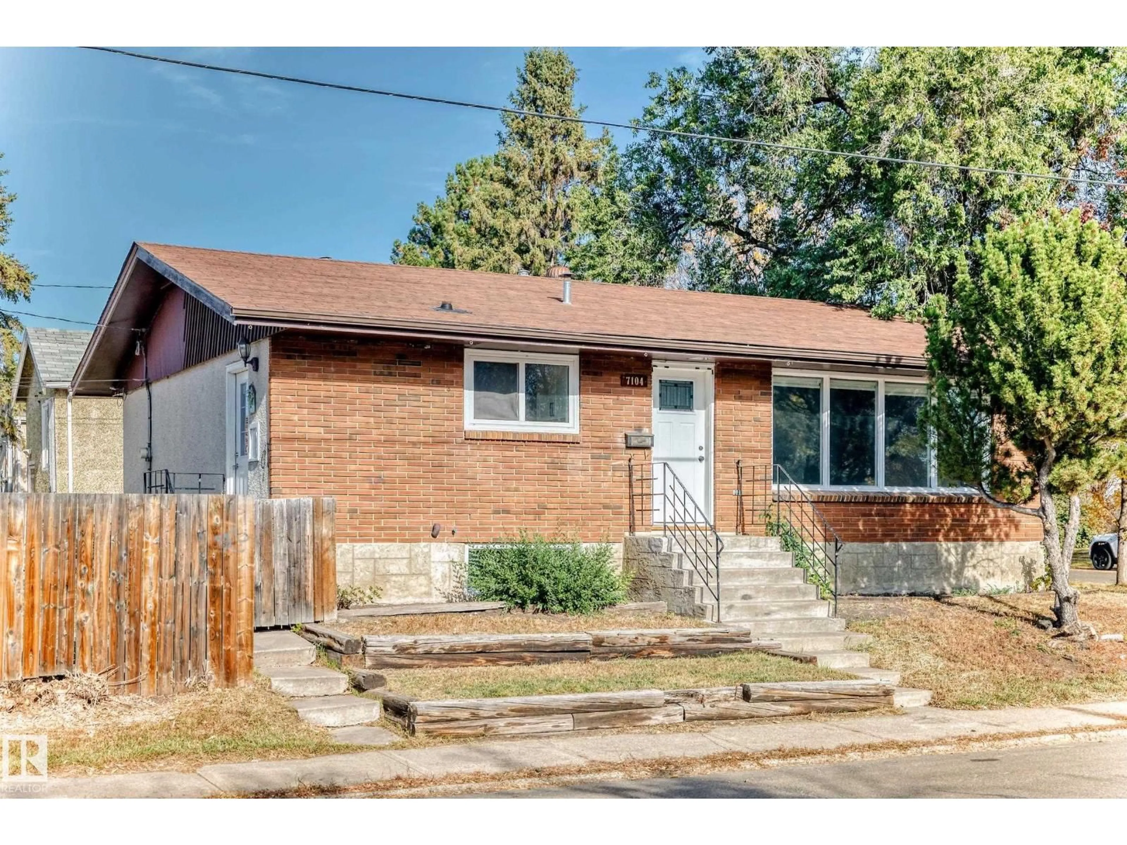 Home with brick exterior material, street for 7104 129 AV, Edmonton Alberta T5C1W1