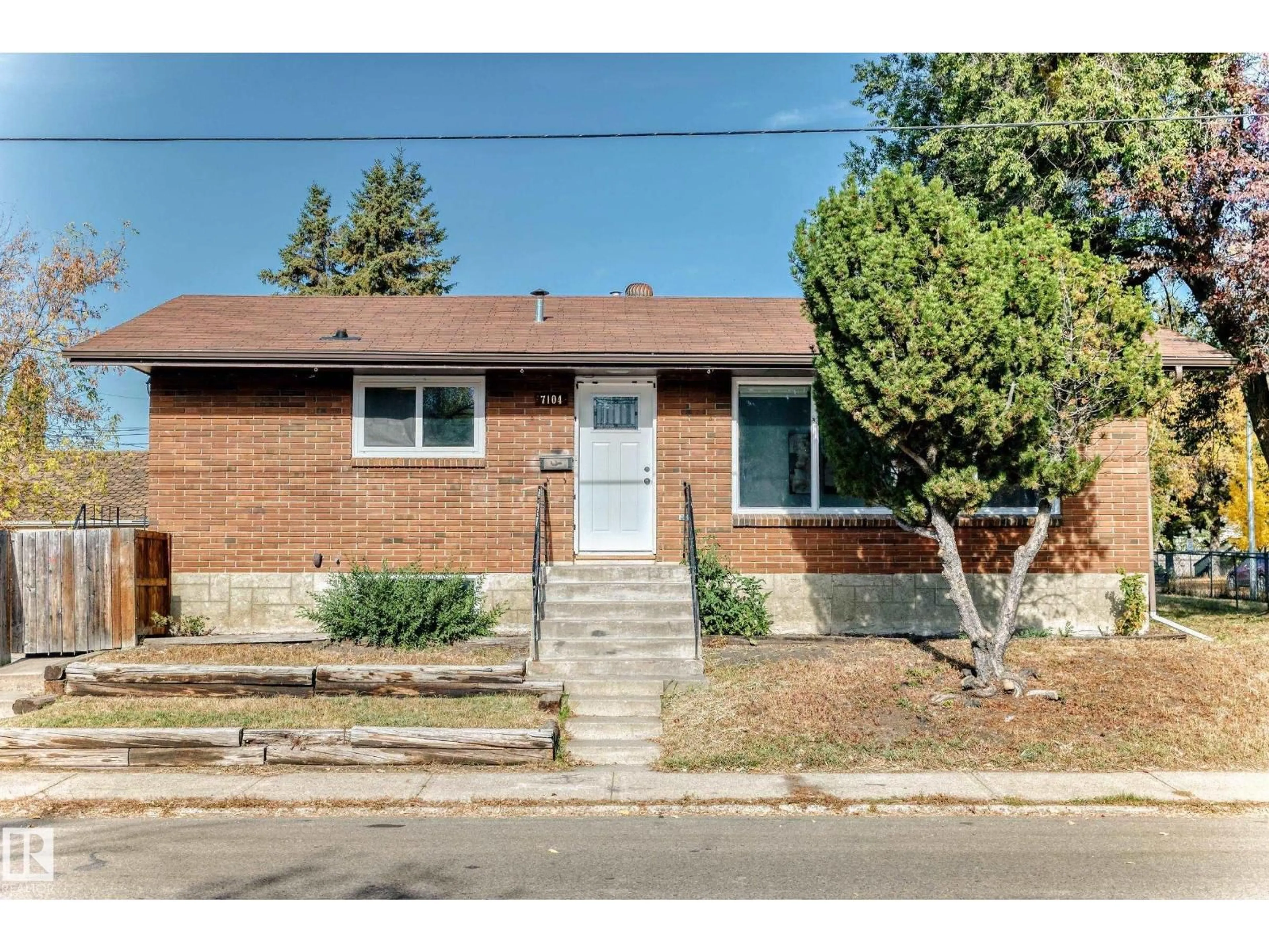Home with brick exterior material, street for 7104 129 AV, Edmonton Alberta T5C1W1