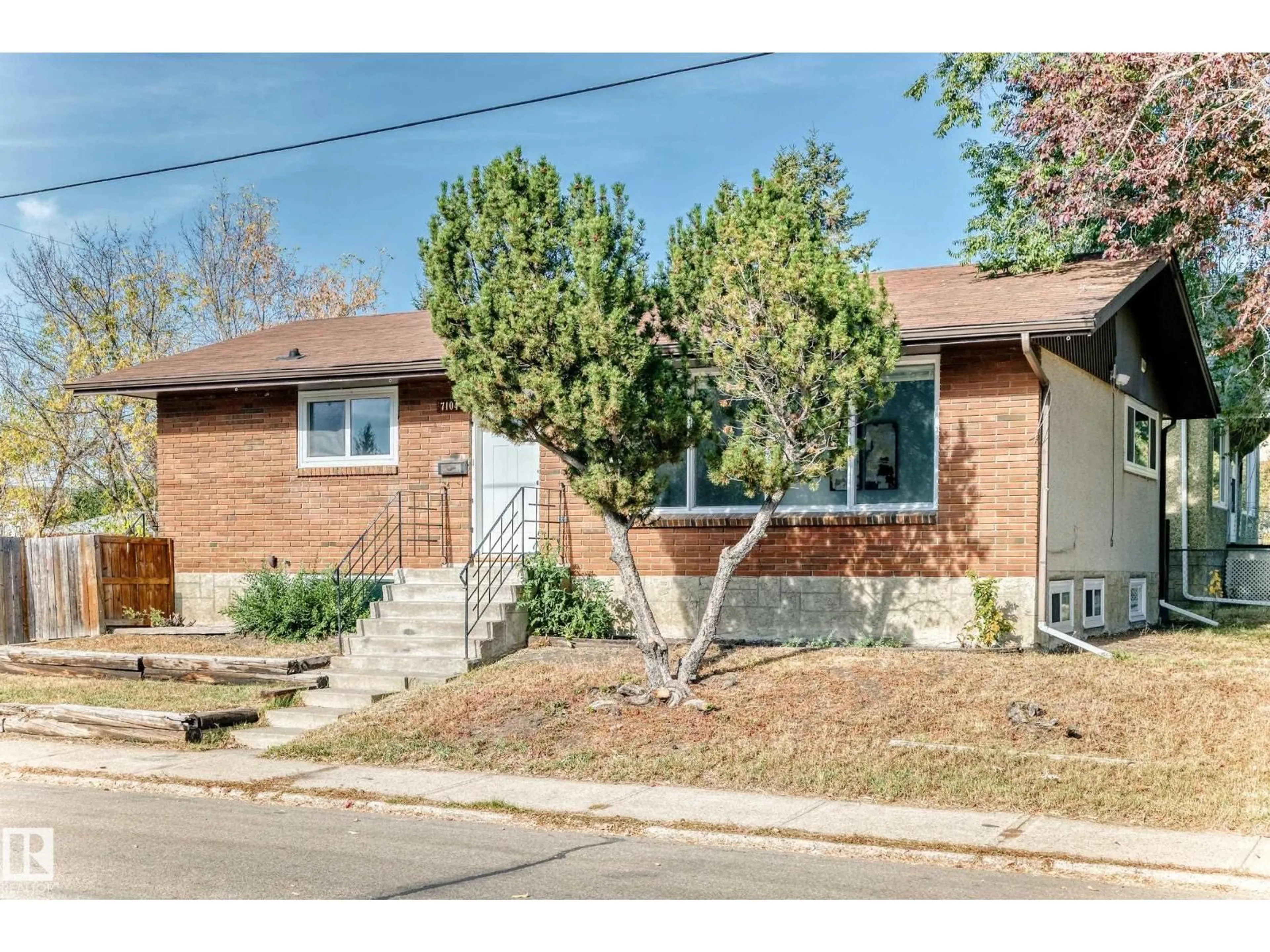 Home with brick exterior material, street for 7104 129 AV, Edmonton Alberta T5C1W1