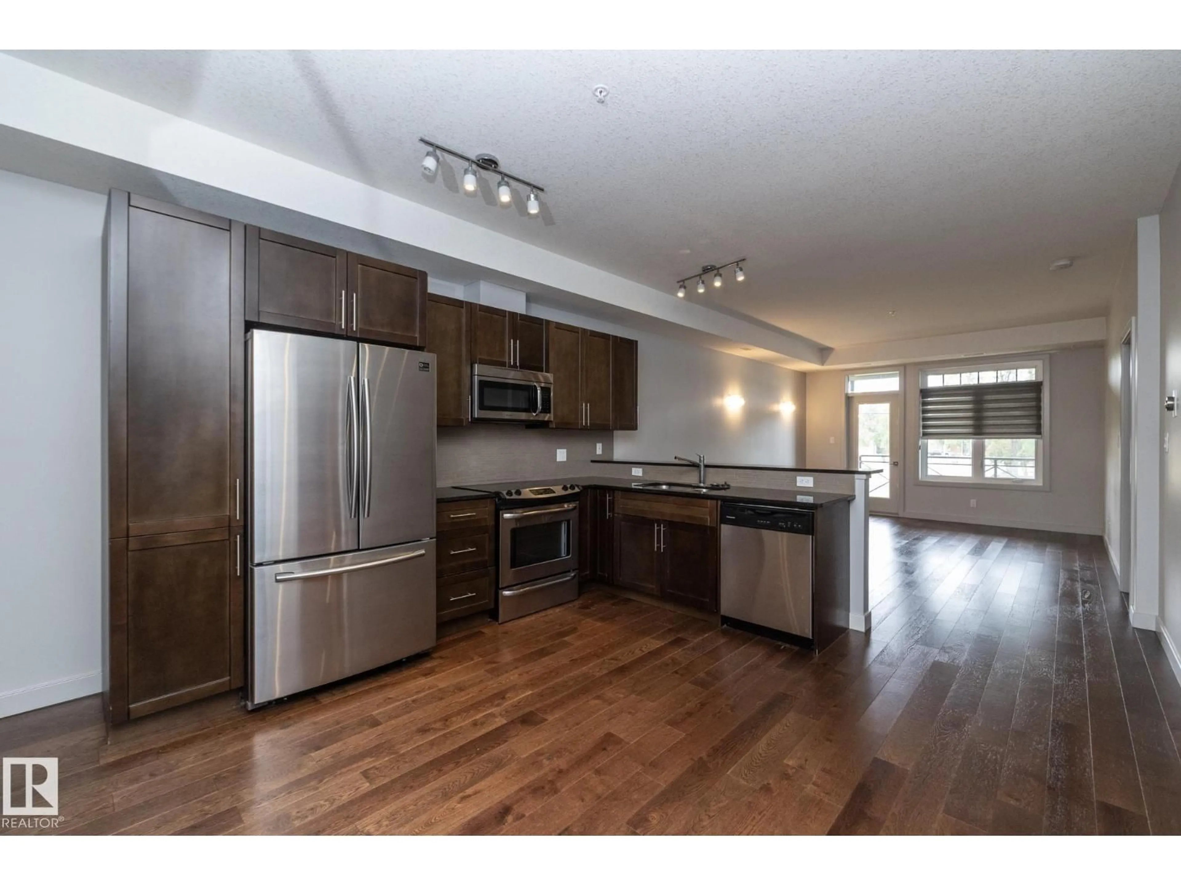 Open concept kitchen, wood/laminate floor for #213 - 10811 72 AV NW, Edmonton Alberta T6E1A4
