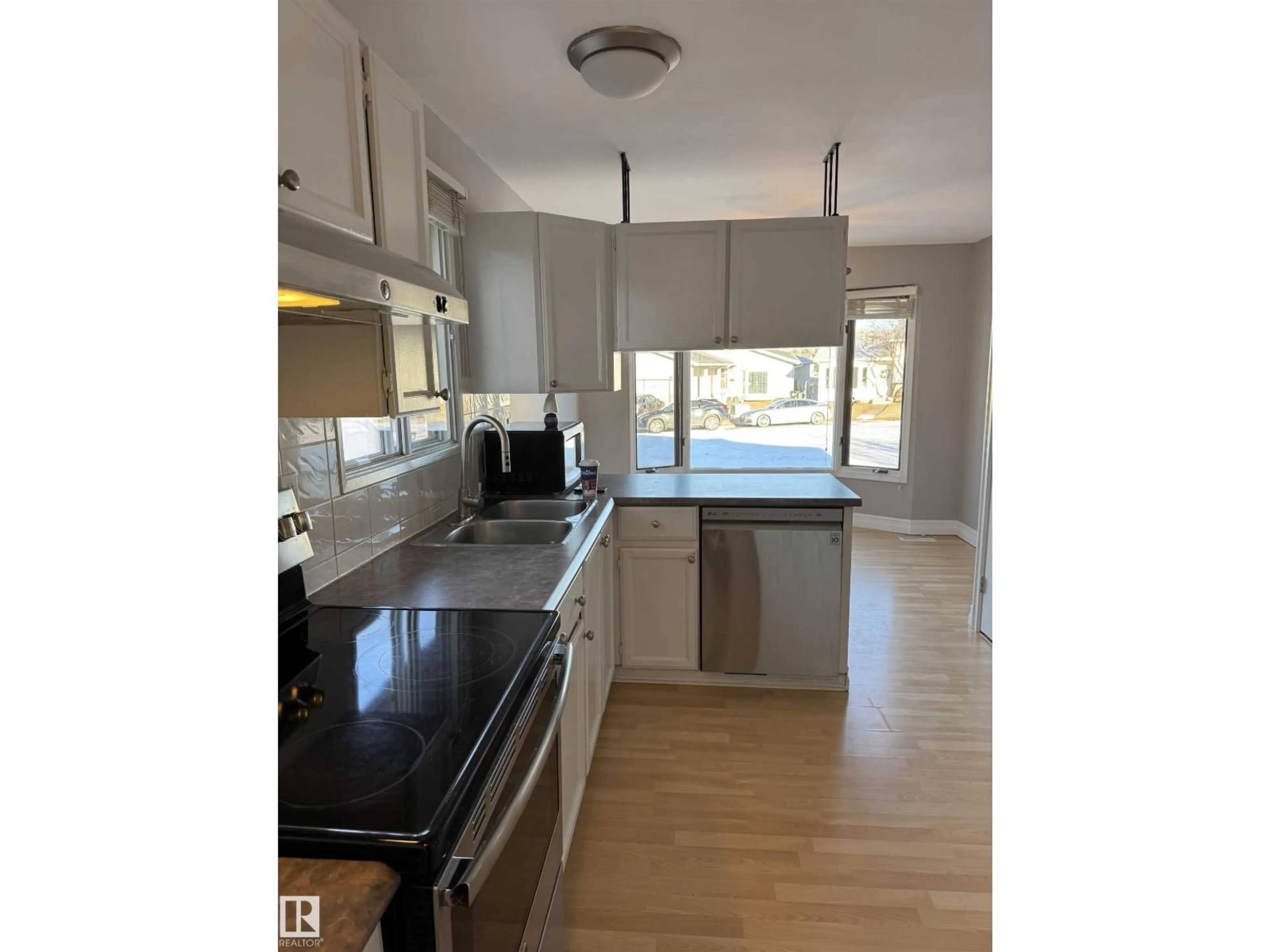 Open concept kitchen, wood/laminate floor for 4111 32 AV, Edmonton Alberta T6L3W6