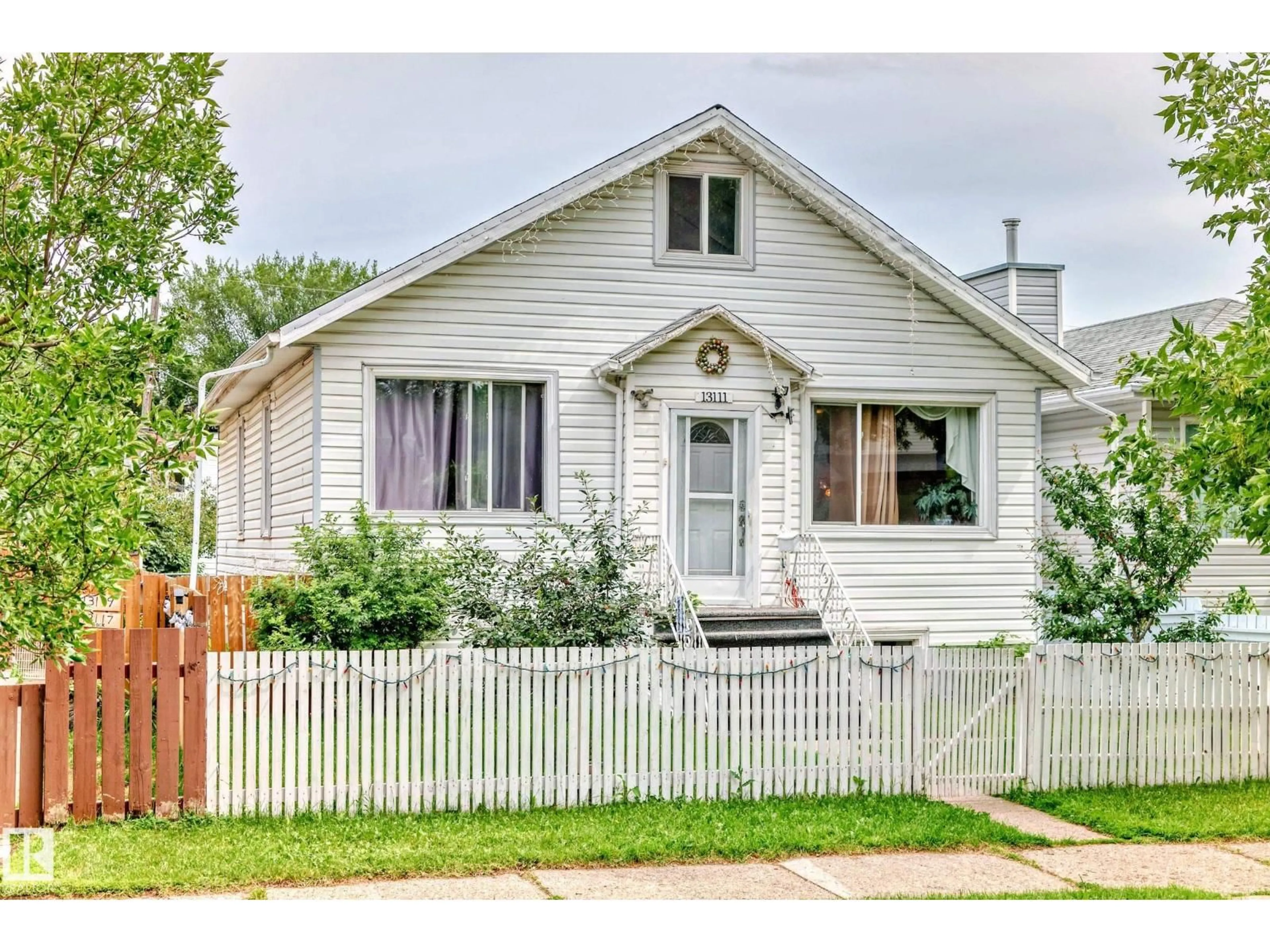 Home with vinyl exterior material, street for 13111 65 ST, Edmonton Alberta T5A1A2