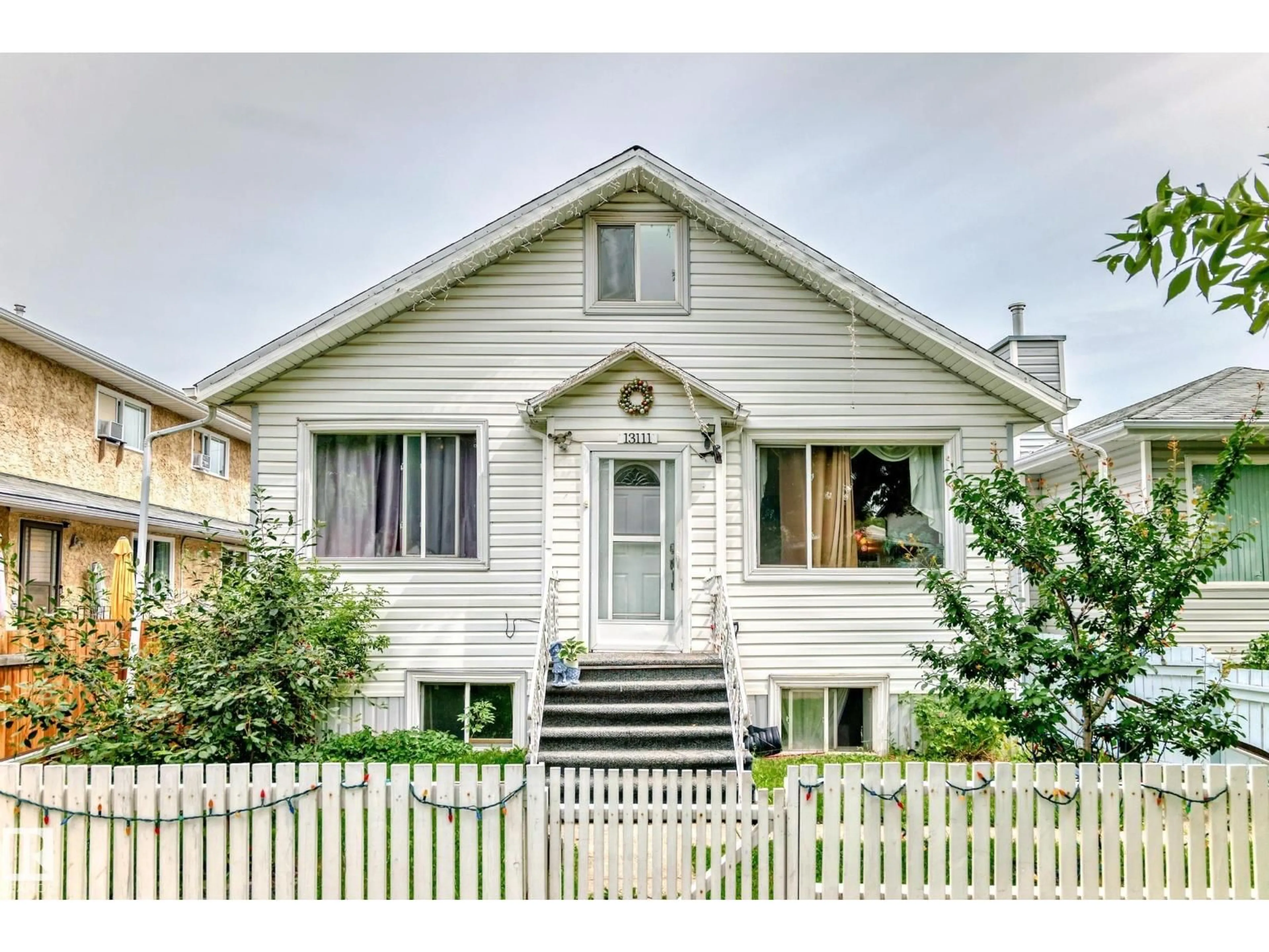 Home with vinyl exterior material, street for 13111 65 ST, Edmonton Alberta T5A1A2