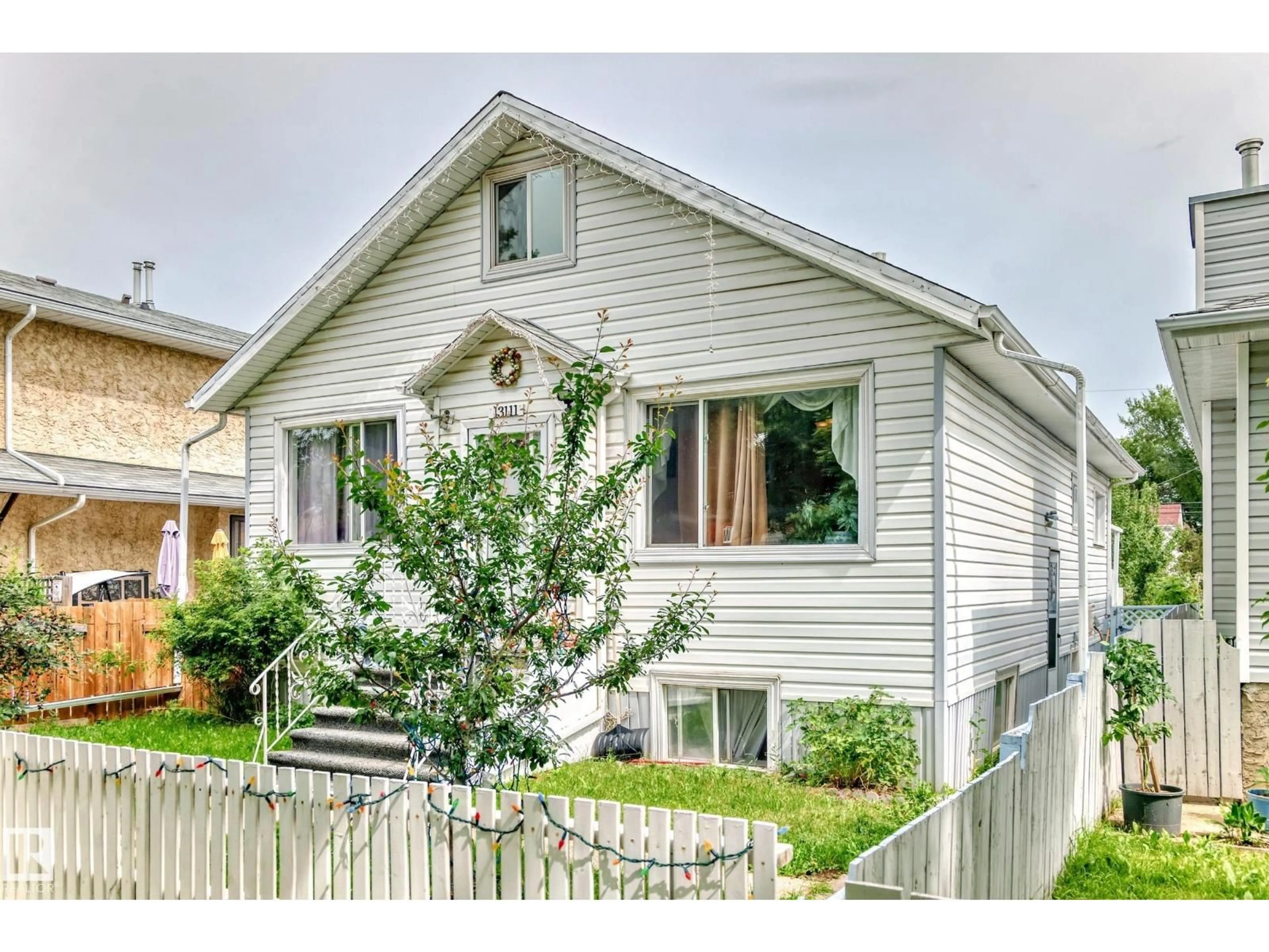 Home with vinyl exterior material, street for 13111 65 ST, Edmonton Alberta T5A1A2