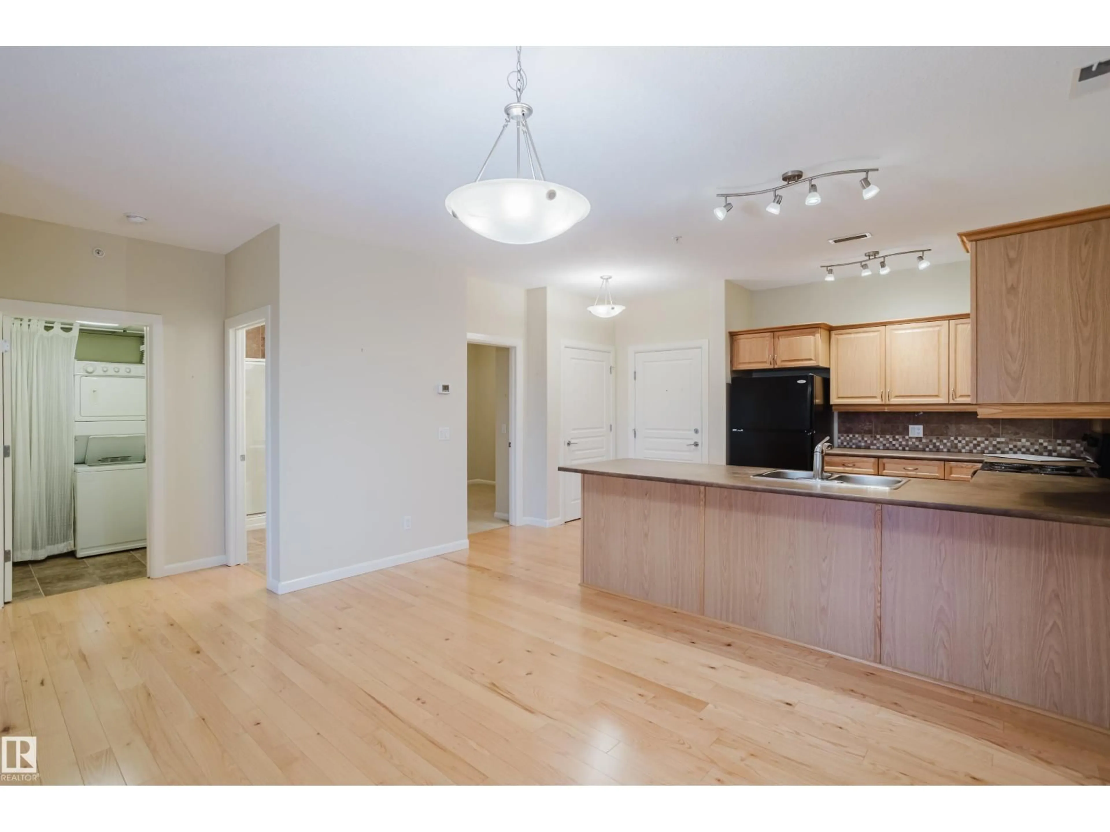 Open concept kitchen, wood/laminate floor for #409 - 160 MAGRATH RD, Edmonton Alberta T6R3T7