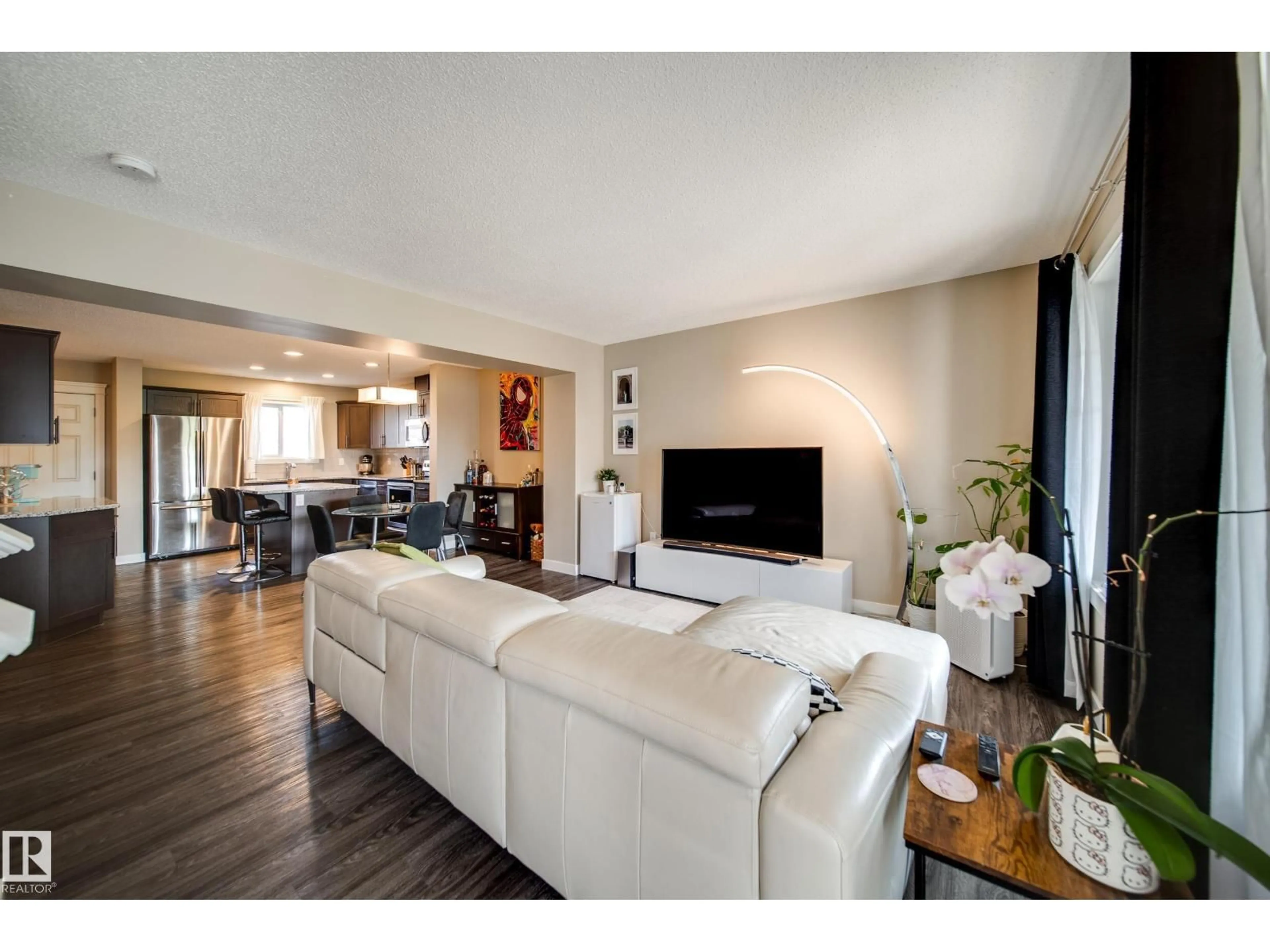 Living room with furniture, wood/laminate floor for SW - 16728 15 AV, Edmonton Alberta T6W3R6