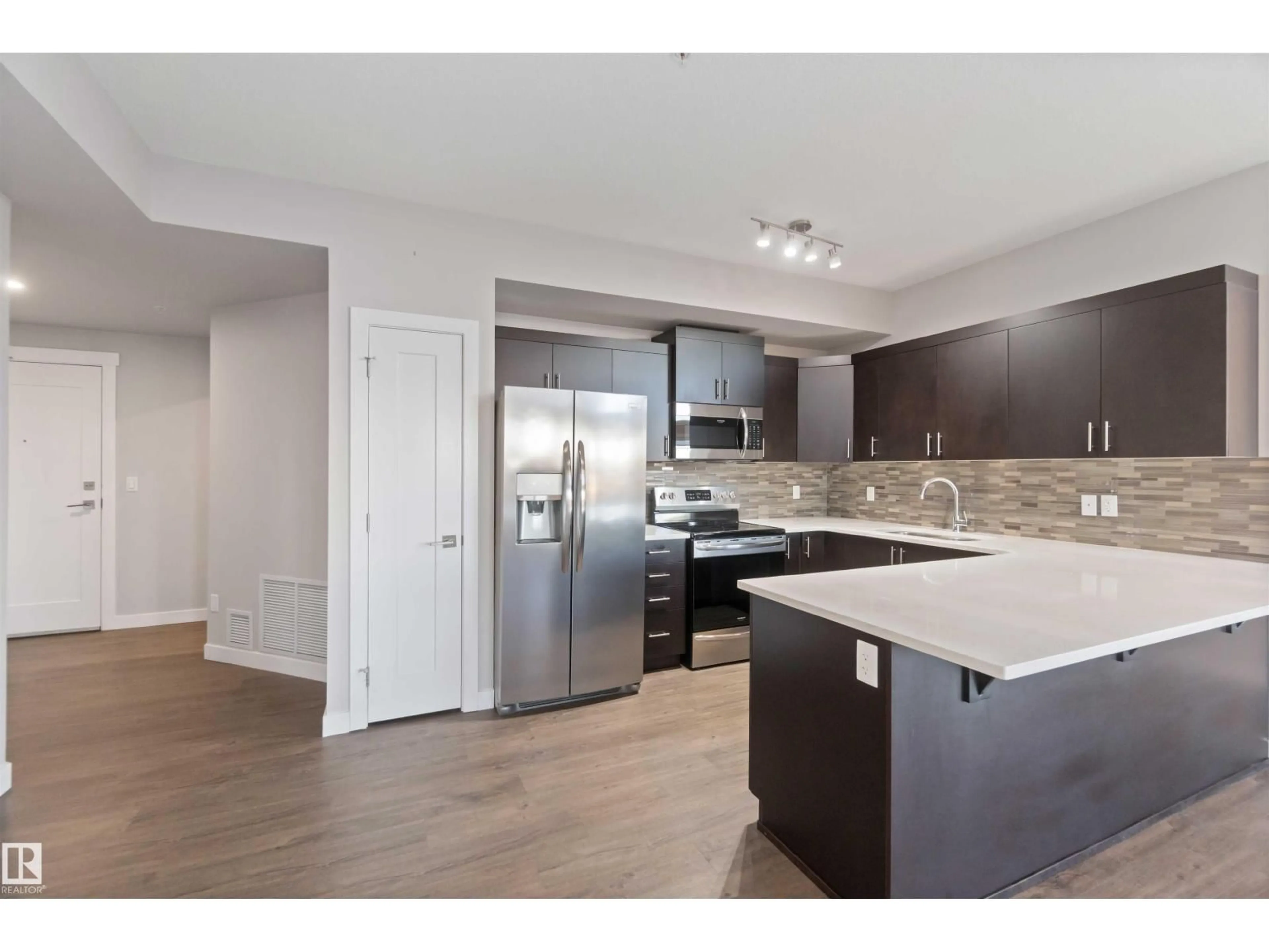 Open concept kitchen, wood/laminate floor for 560 - 410 GRIESBACH PARADE PR NW, Edmonton Alberta T5E6K1