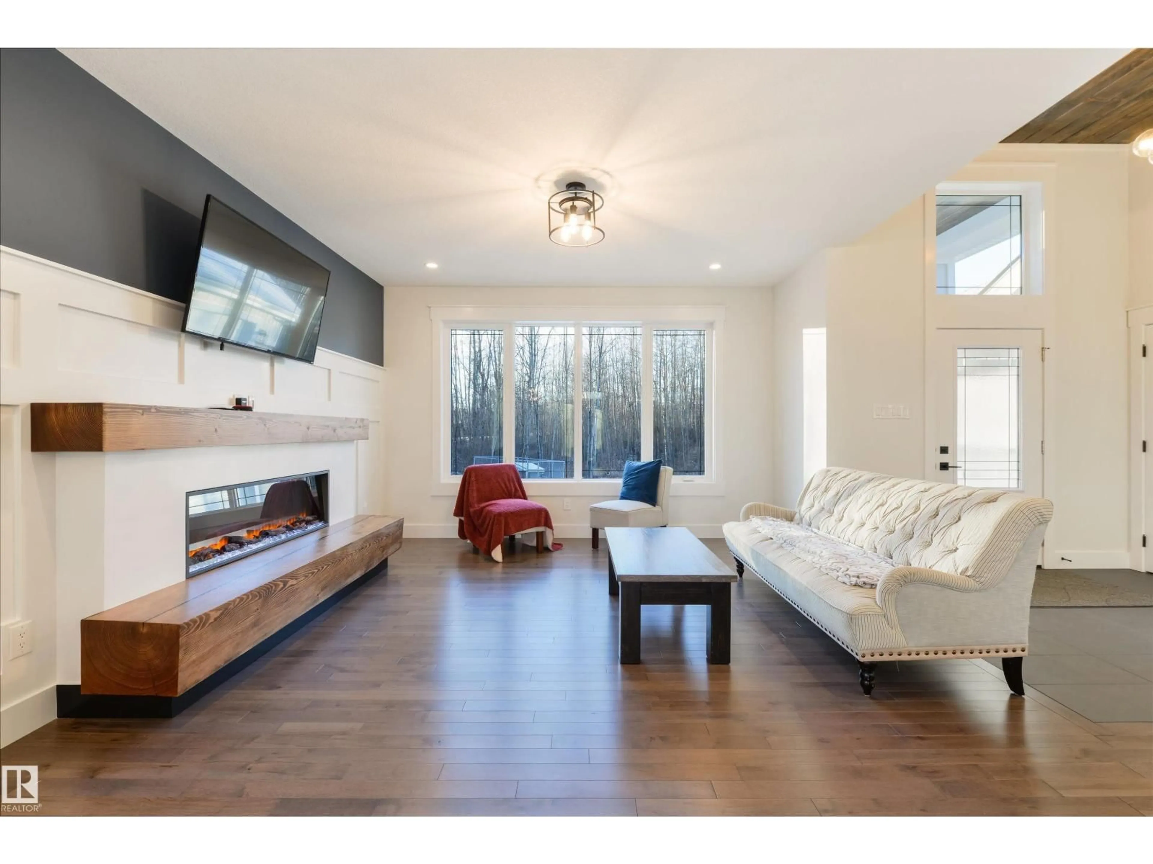 Living room with furniture, wood/laminate floor for #14 - 2406 TWP ROAD 540, Rural Lac Ste. Anne County Alberta T0E1V0