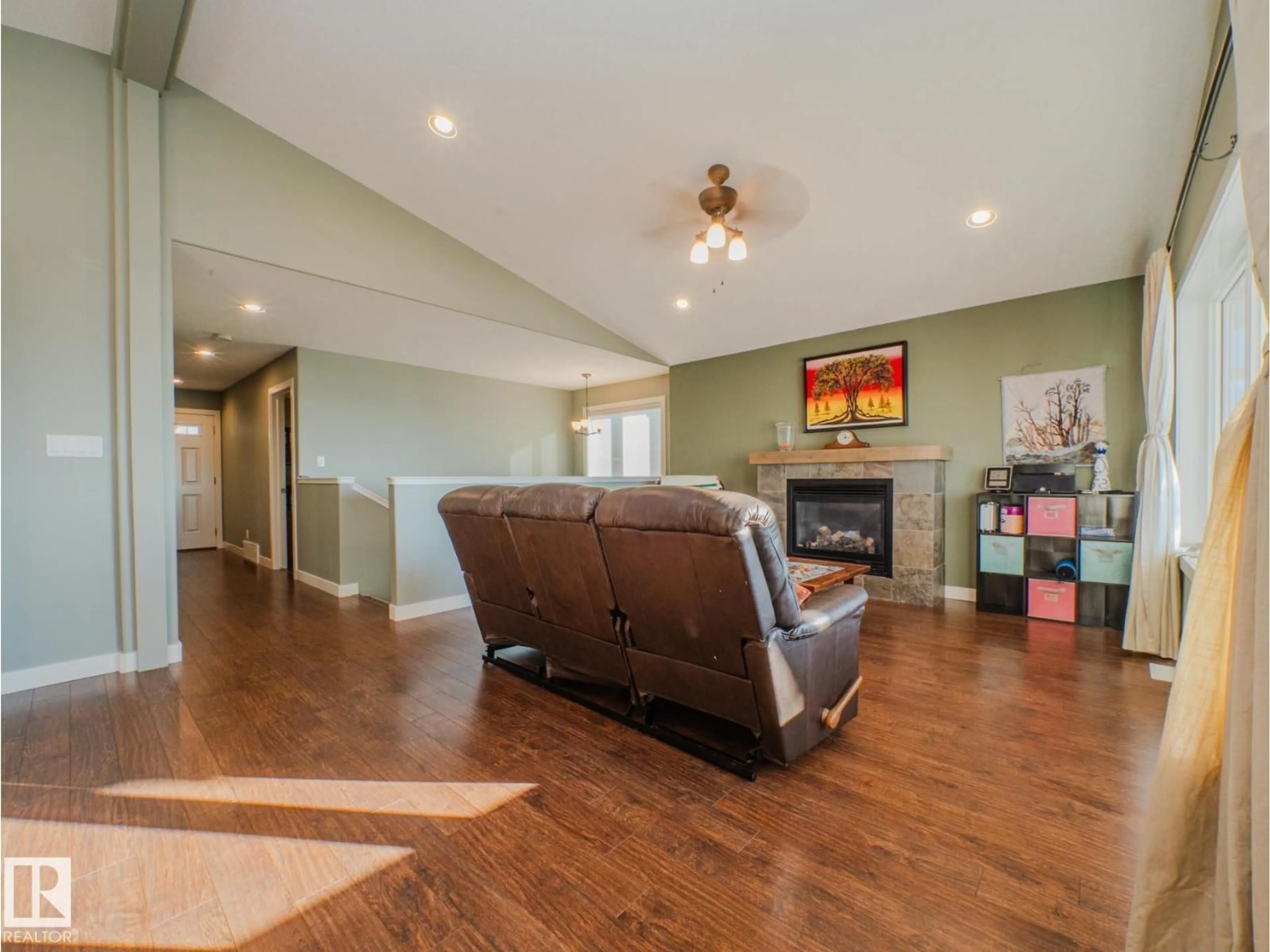 Living room with furniture, wood/laminate floor for 55101 - 521 STE. ANNE TR, Rural Lac Ste. Anne County Alberta T0E1A1