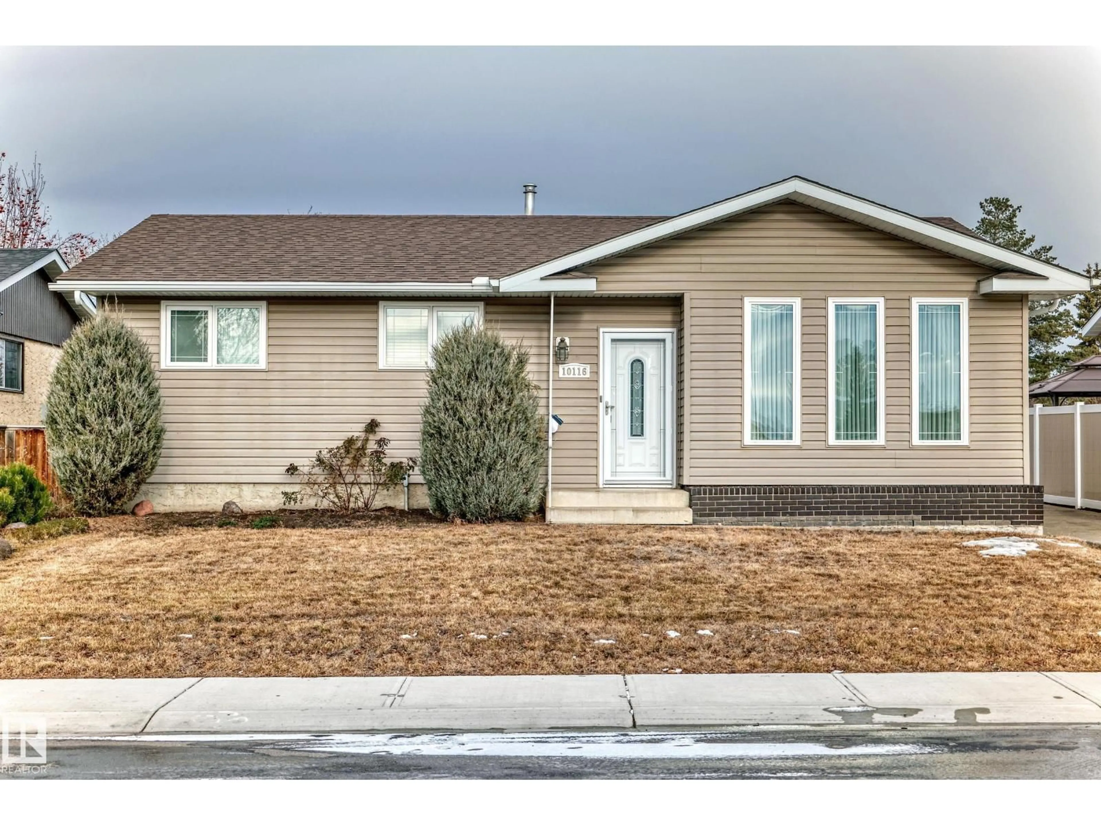 Home with vinyl exterior material, street for NW - 10116 166 AV, Edmonton Alberta T5X2G5