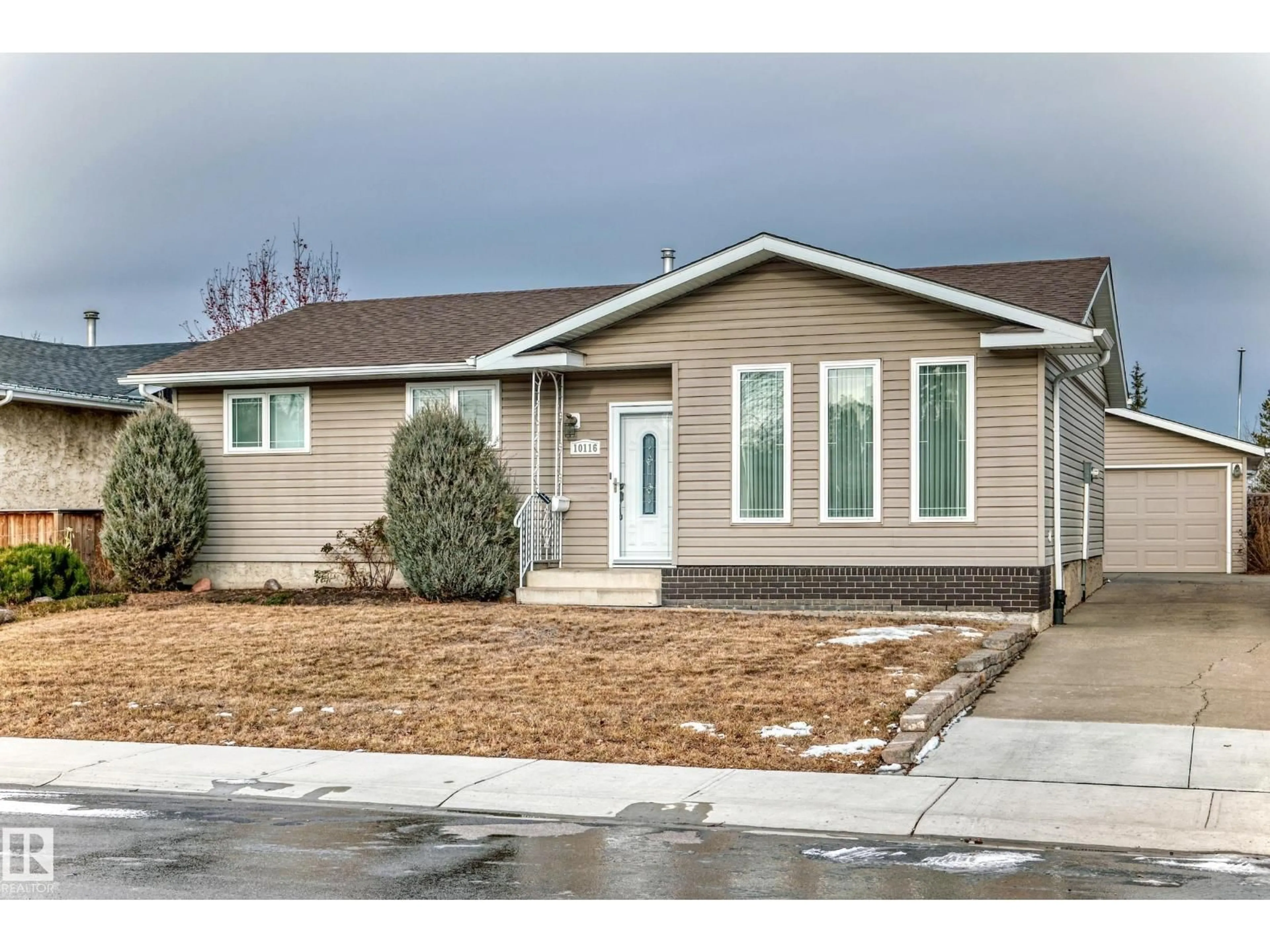 Home with vinyl exterior material, street for NW - 10116 166 AV, Edmonton Alberta T5X2G5