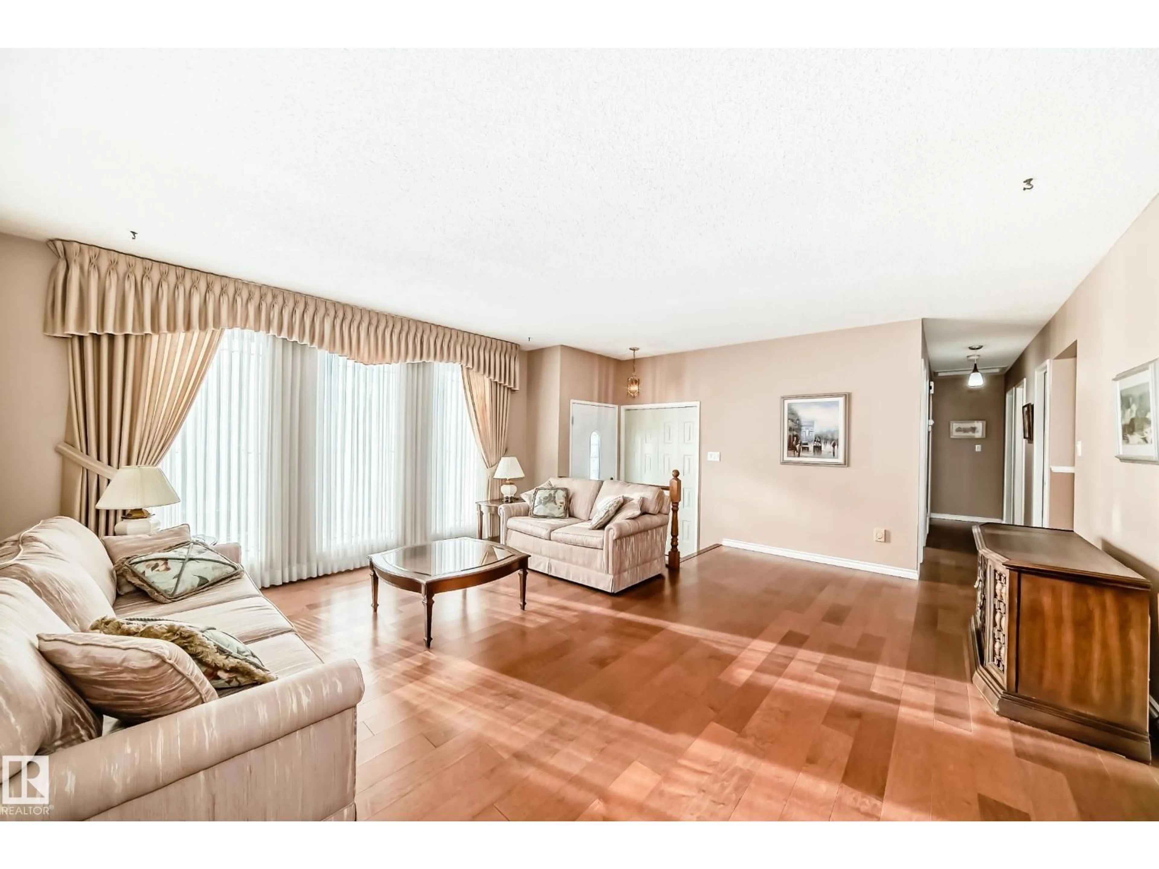 Living room with furniture, wood/laminate floor for NW - 10116 166 AV, Edmonton Alberta T5X2G5