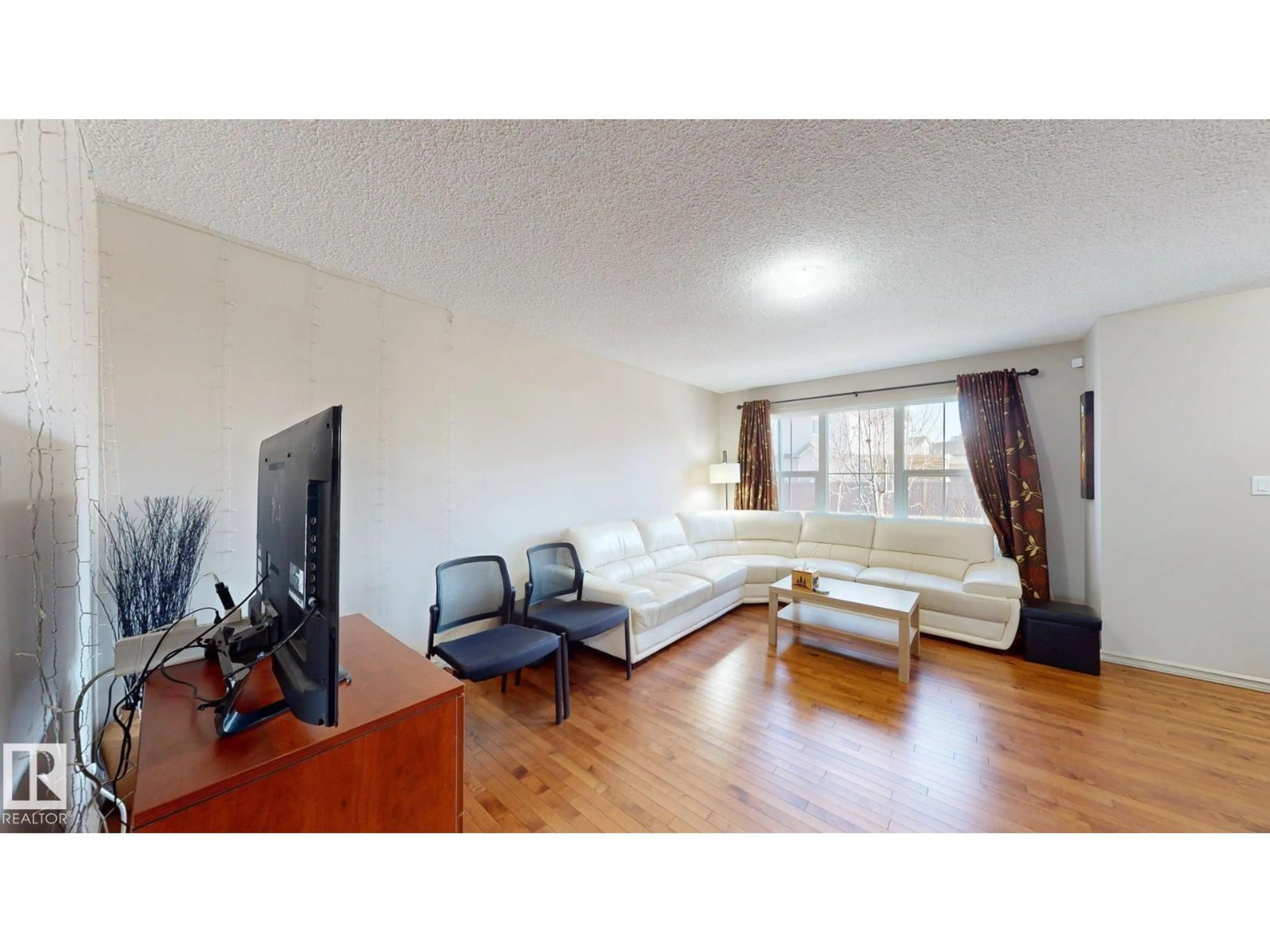 Living room with furniture, wood/laminate floor for 1708 62 ST, Edmonton Alberta T6X0W2