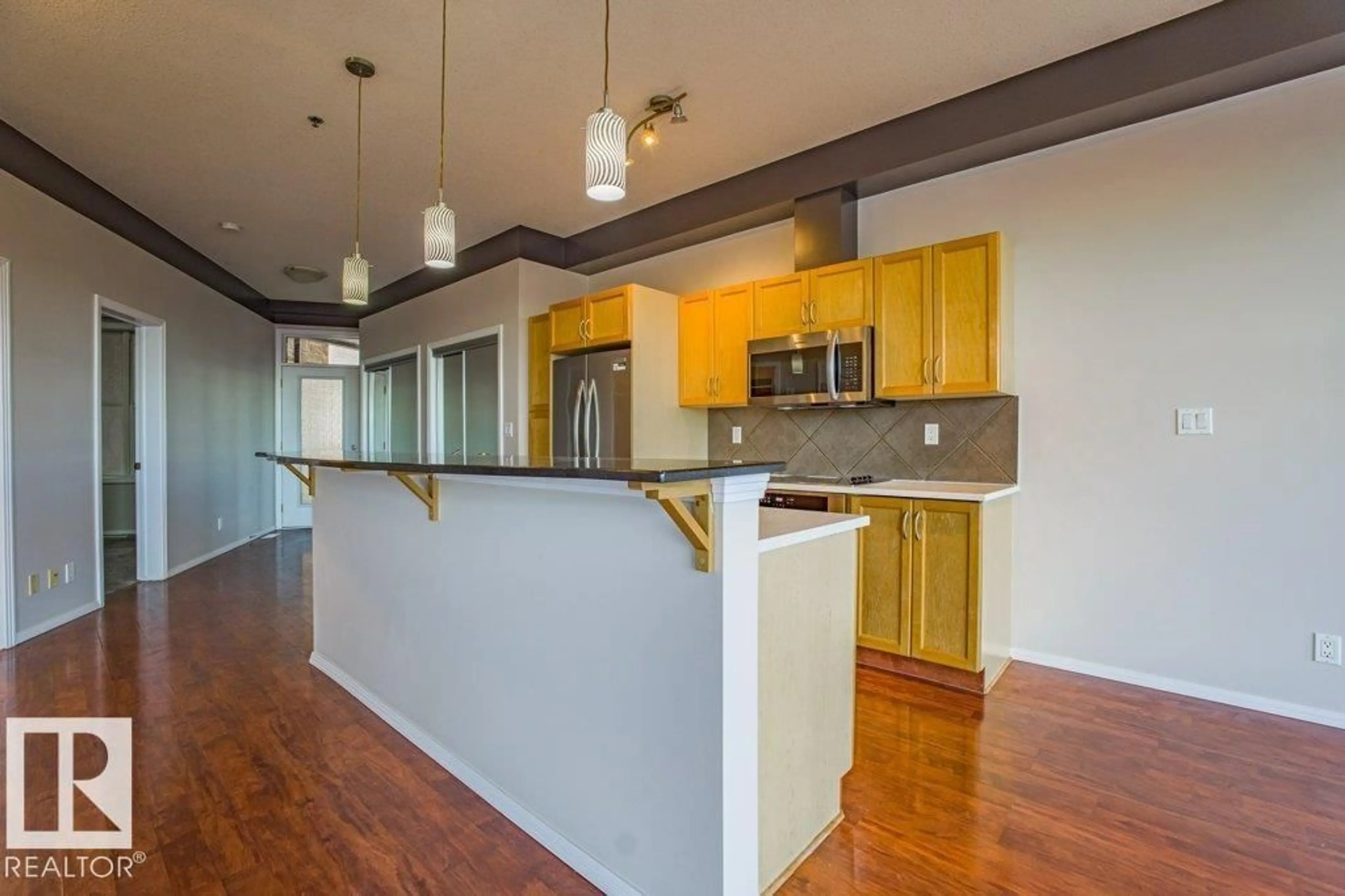 Open concept kitchen, wood/laminate floor for 403 - 4835 104 A ST, Edmonton Alberta T6H0R5