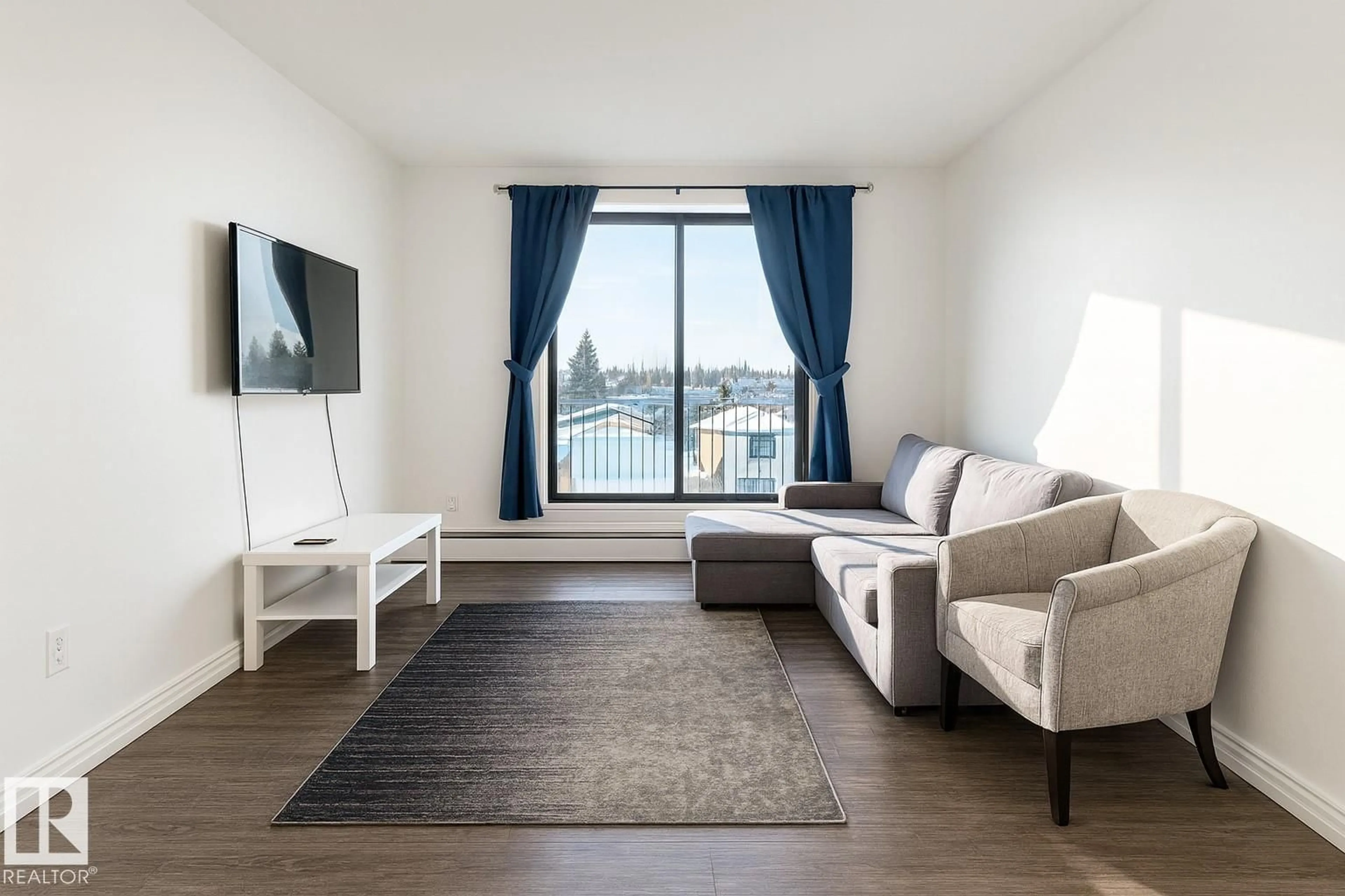 Living room with furniture, wood/laminate floor for 404 - 3610 43 AV NW, Edmonton Alberta T6L5T2