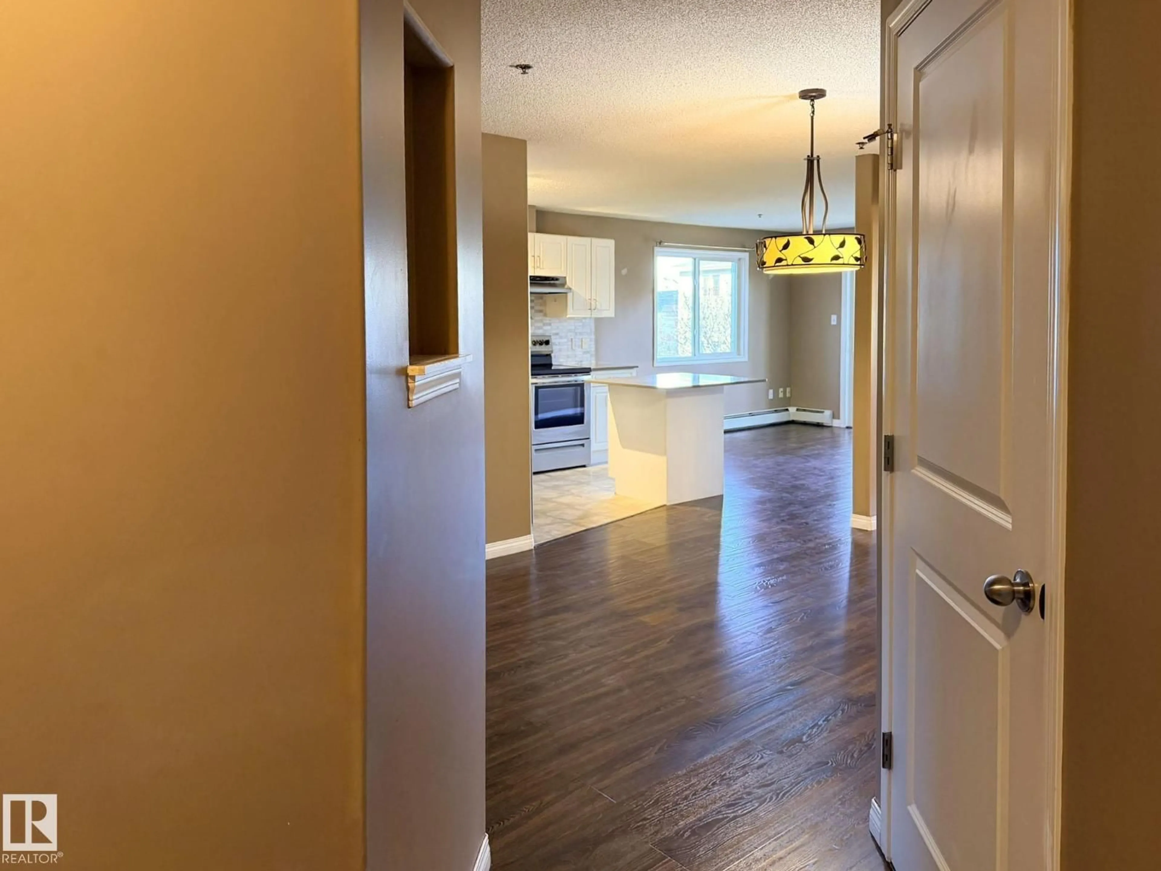 Open concept kitchen, wood/laminate floor for #227 - 2305 35A AV, Edmonton Alberta T6T1Z2