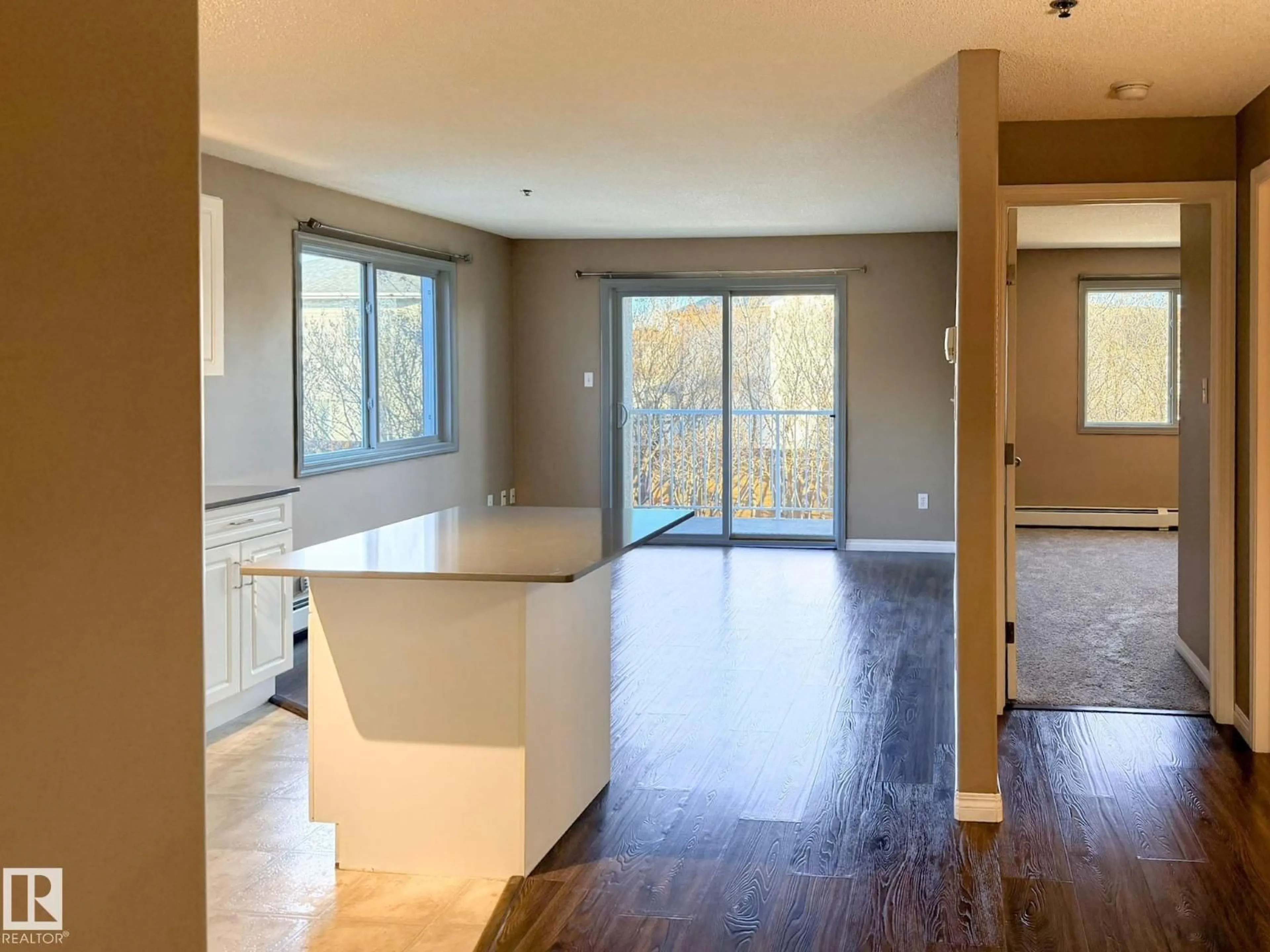 Open concept kitchen, wood/laminate floor for #227 - 2305 35A AV, Edmonton Alberta T6T1Z2