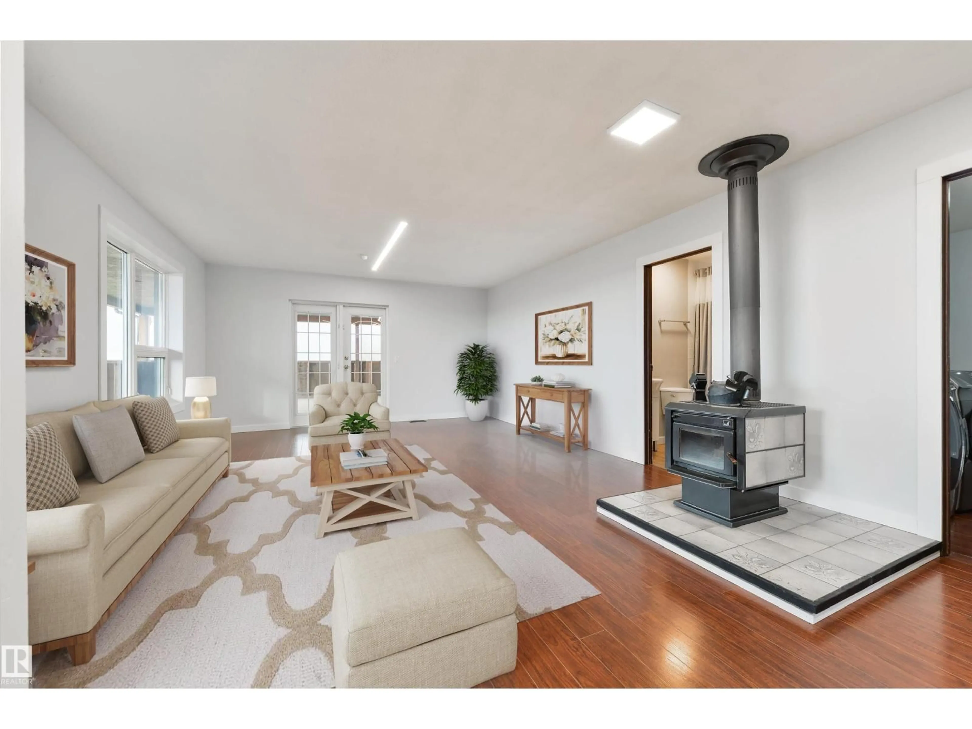 Living room with furniture, wood/laminate floor for 51328 RGE ROAD 24, Rural Parkland County Alberta T7Y2K4