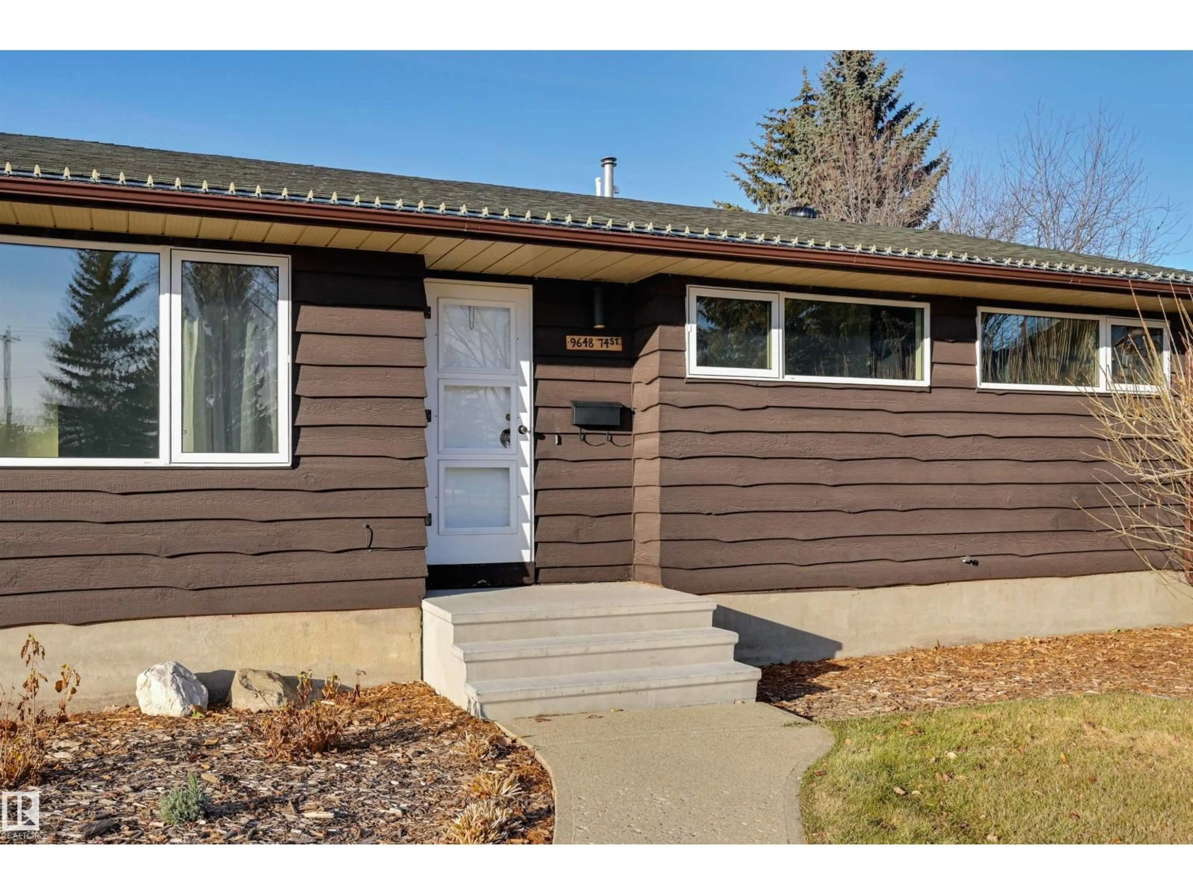 Home with vinyl exterior material, street for 9648 74 ST NW, Edmonton Alberta T6B2B9
