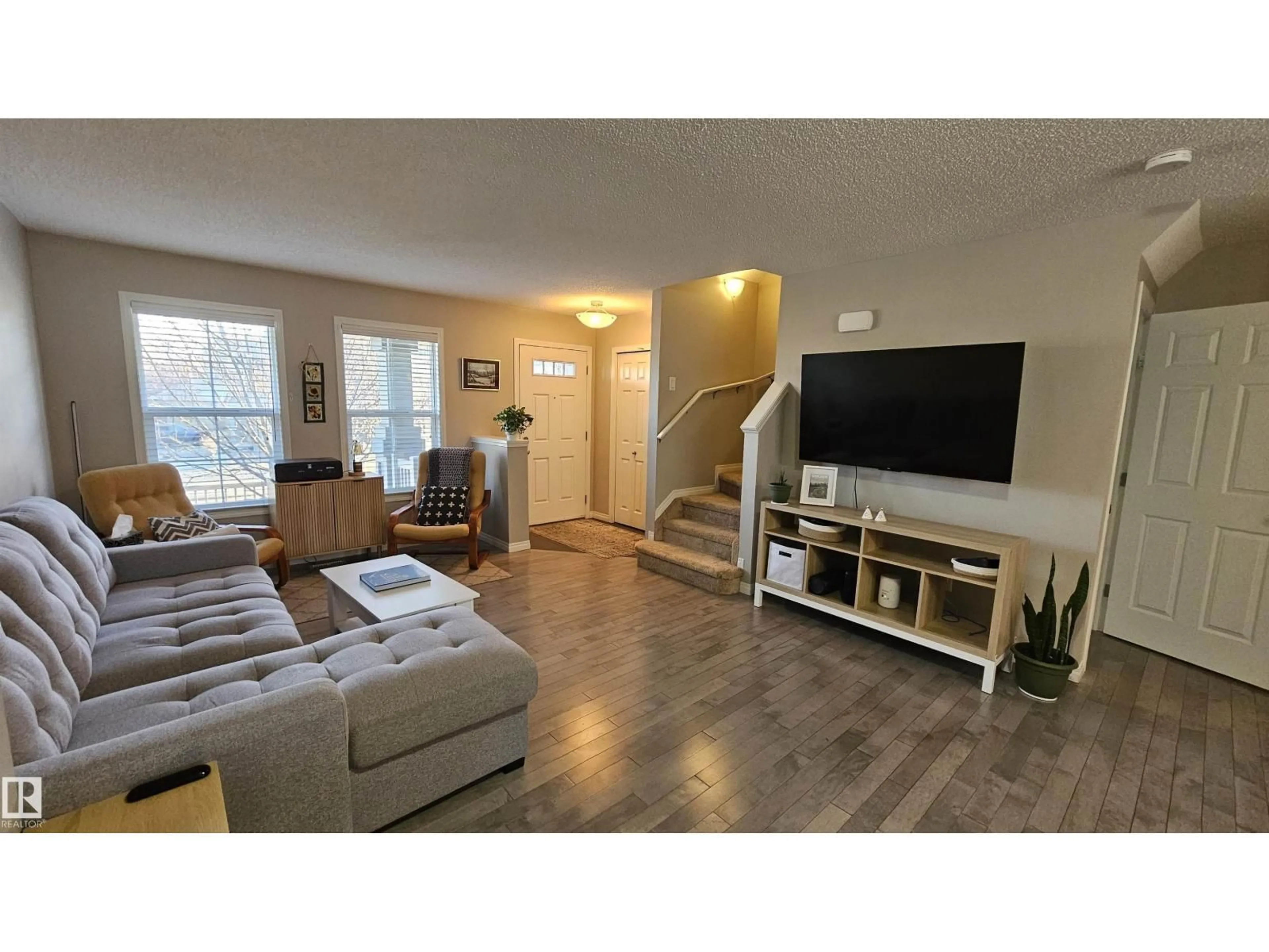 Living room with furniture, wood/laminate floor for 585 ORCHARDS BV, Edmonton Alberta T6X1V2