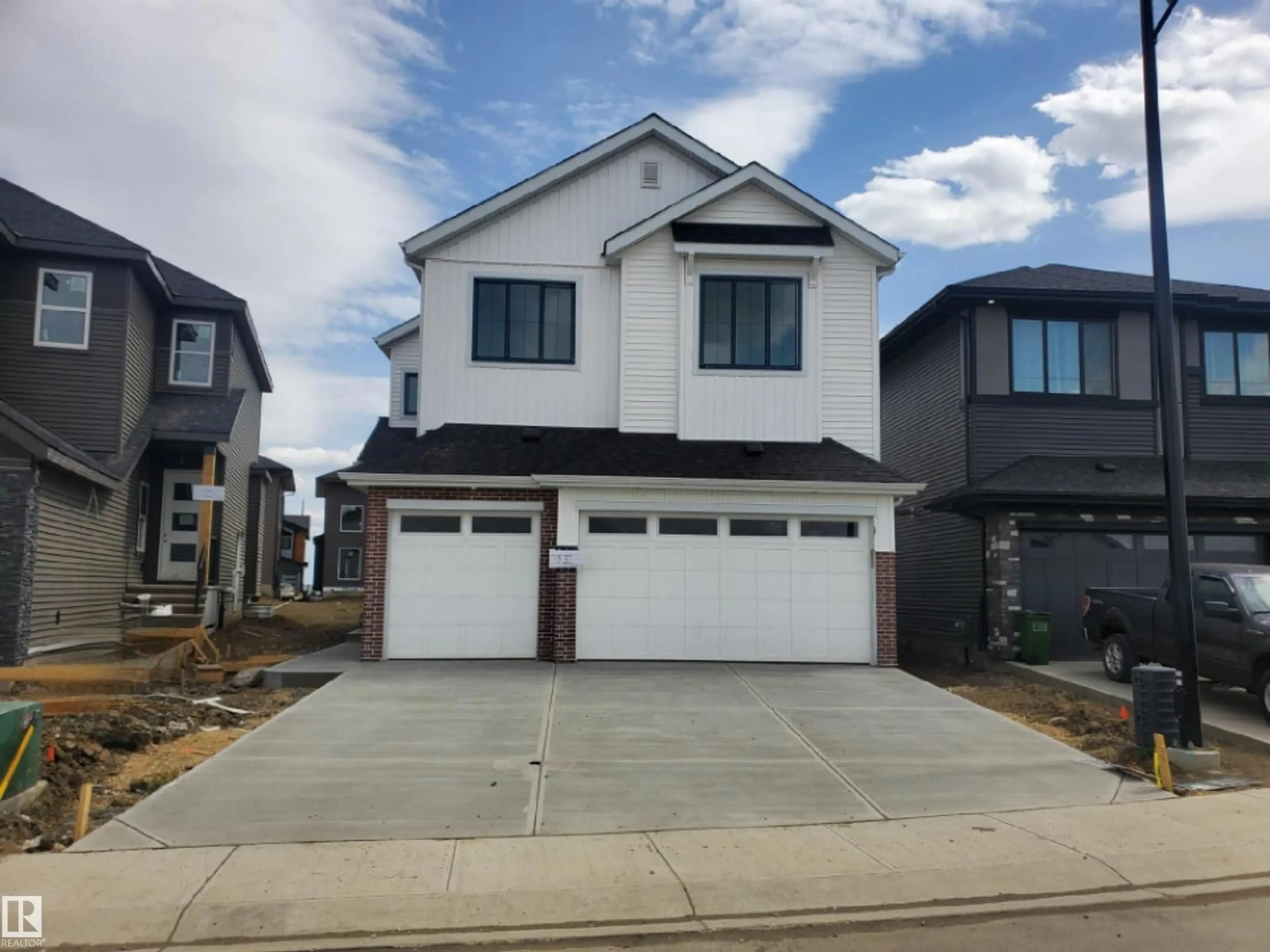 Home with vinyl exterior material, street for 17115 3 ST, Edmonton Alberta T5Y4G8