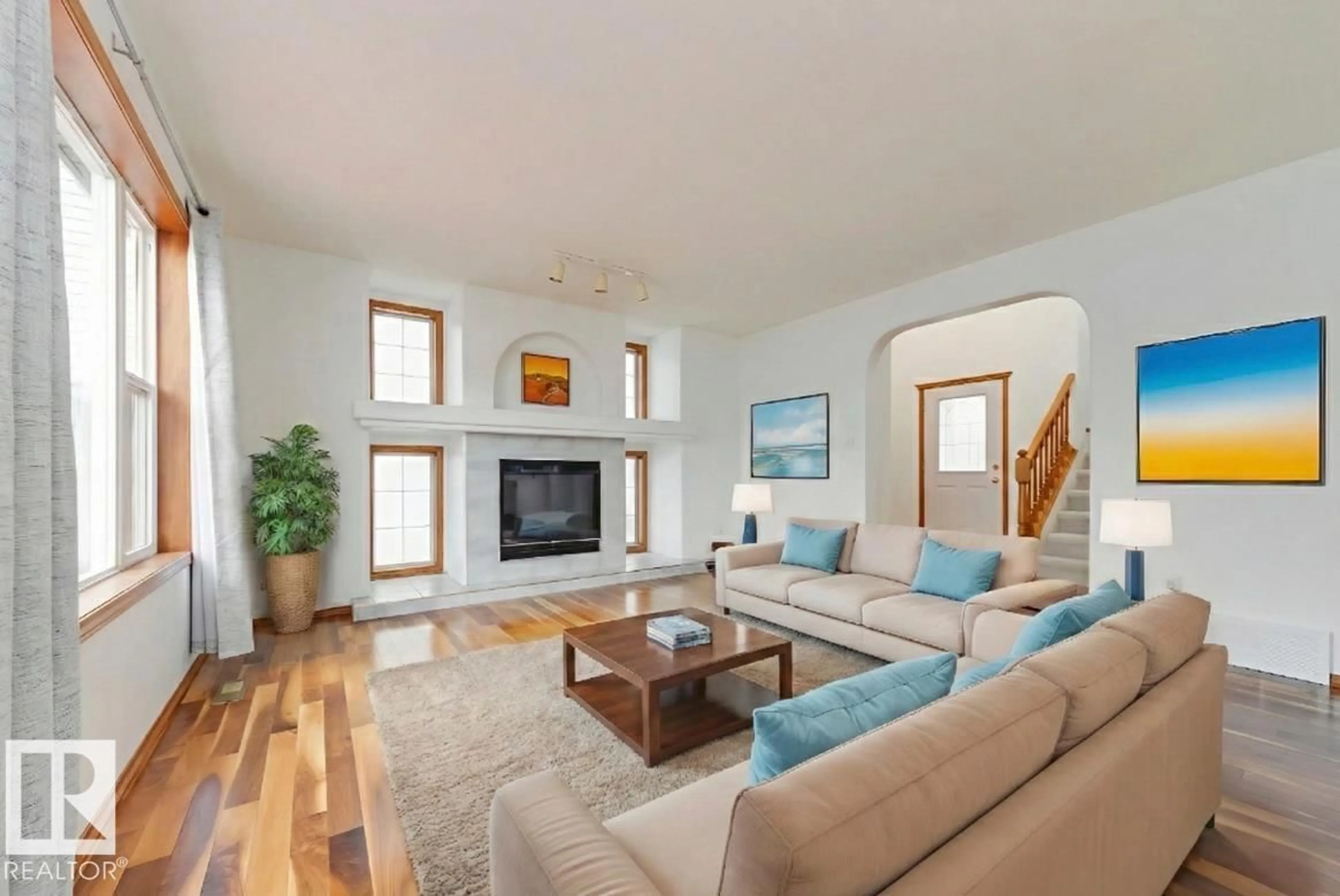 Living room with furniture, wood/laminate floor for 13323 155 AV, Edmonton Alberta T6V1K5