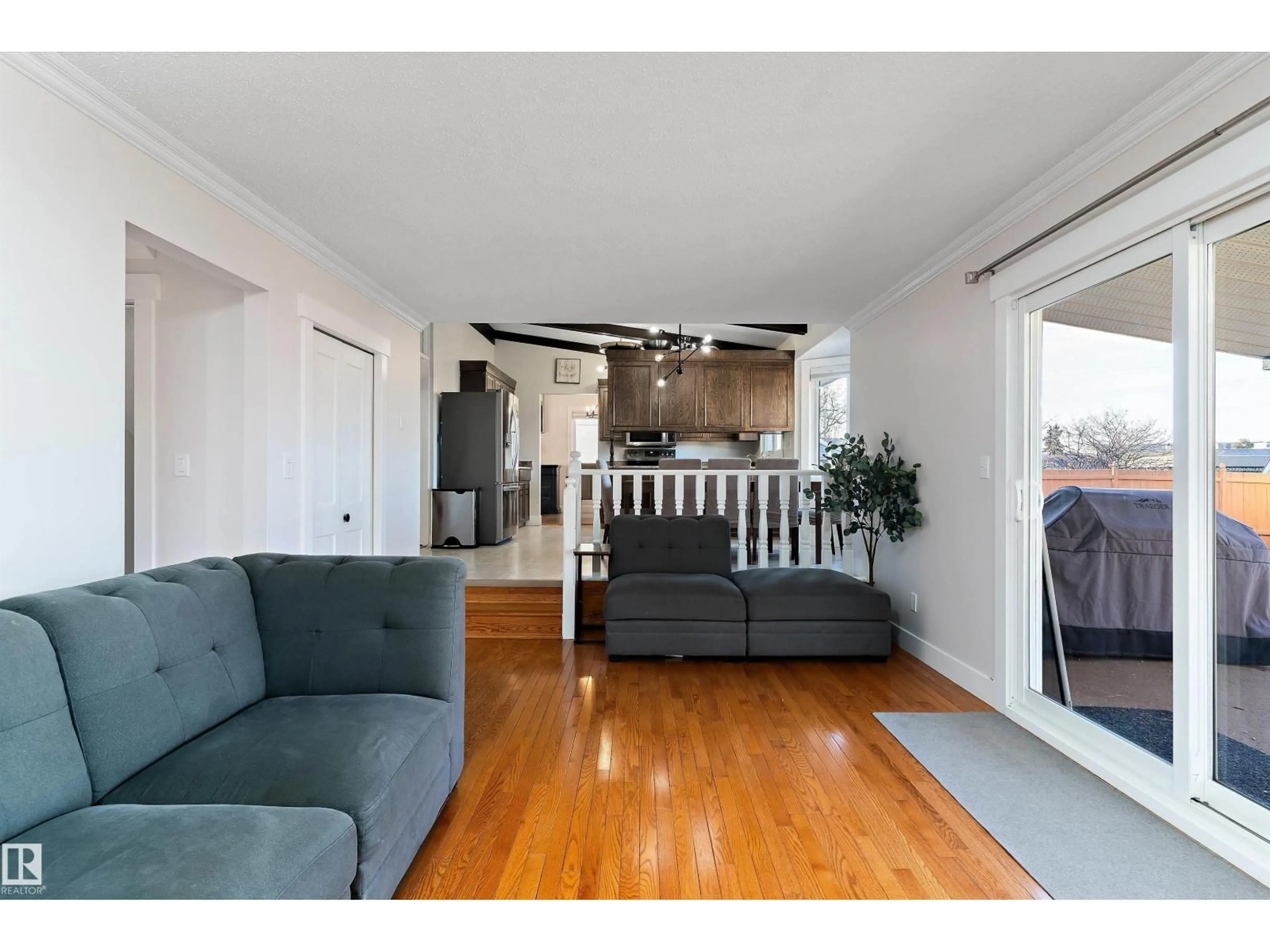 Living room with furniture, wood/laminate floor for NW - 3026 105A ST, Edmonton Alberta T6J3A5