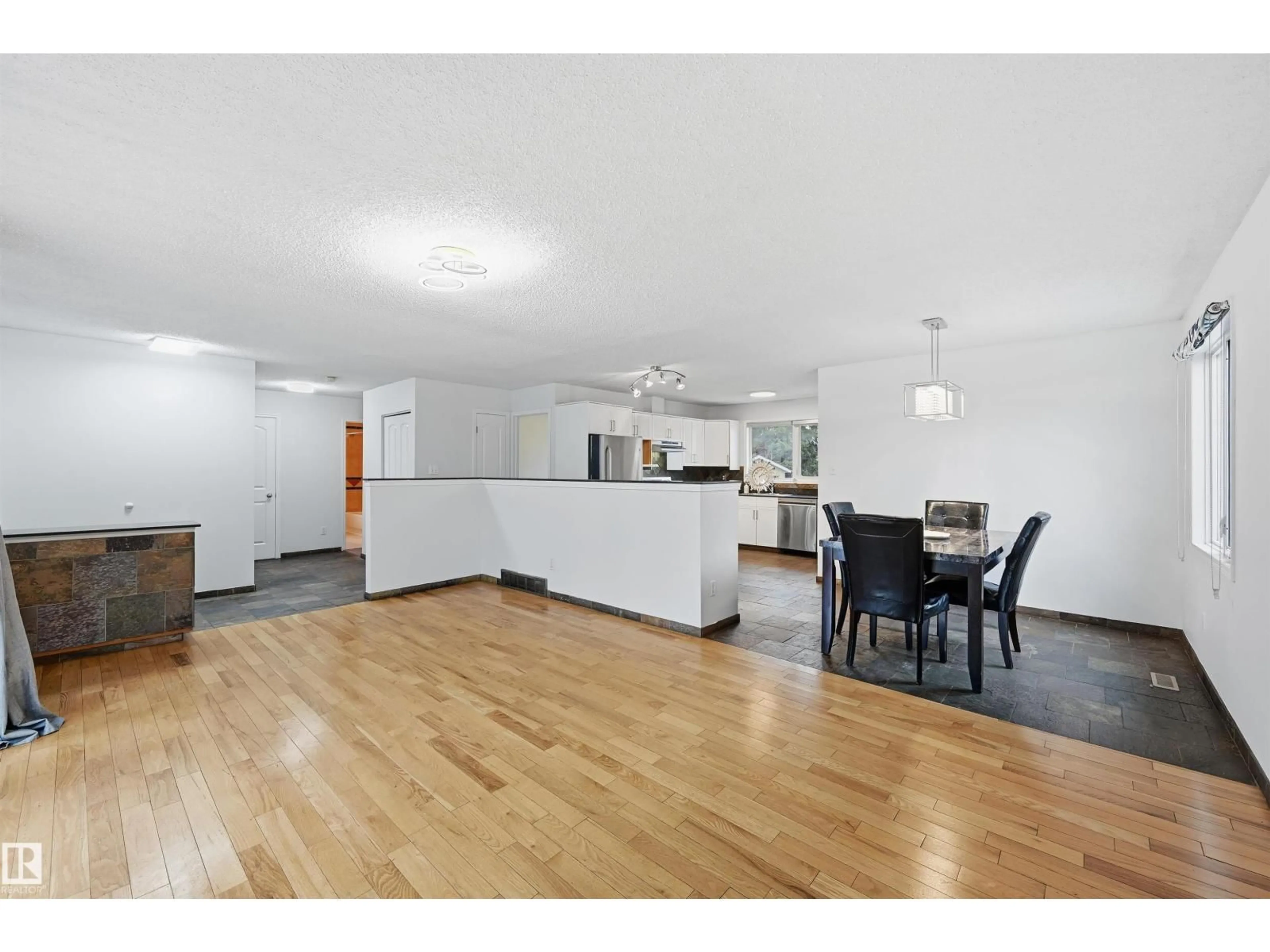 Open concept kitchen, wood/laminate floor for 4240 86 ST, Edmonton Alberta T6K1C4