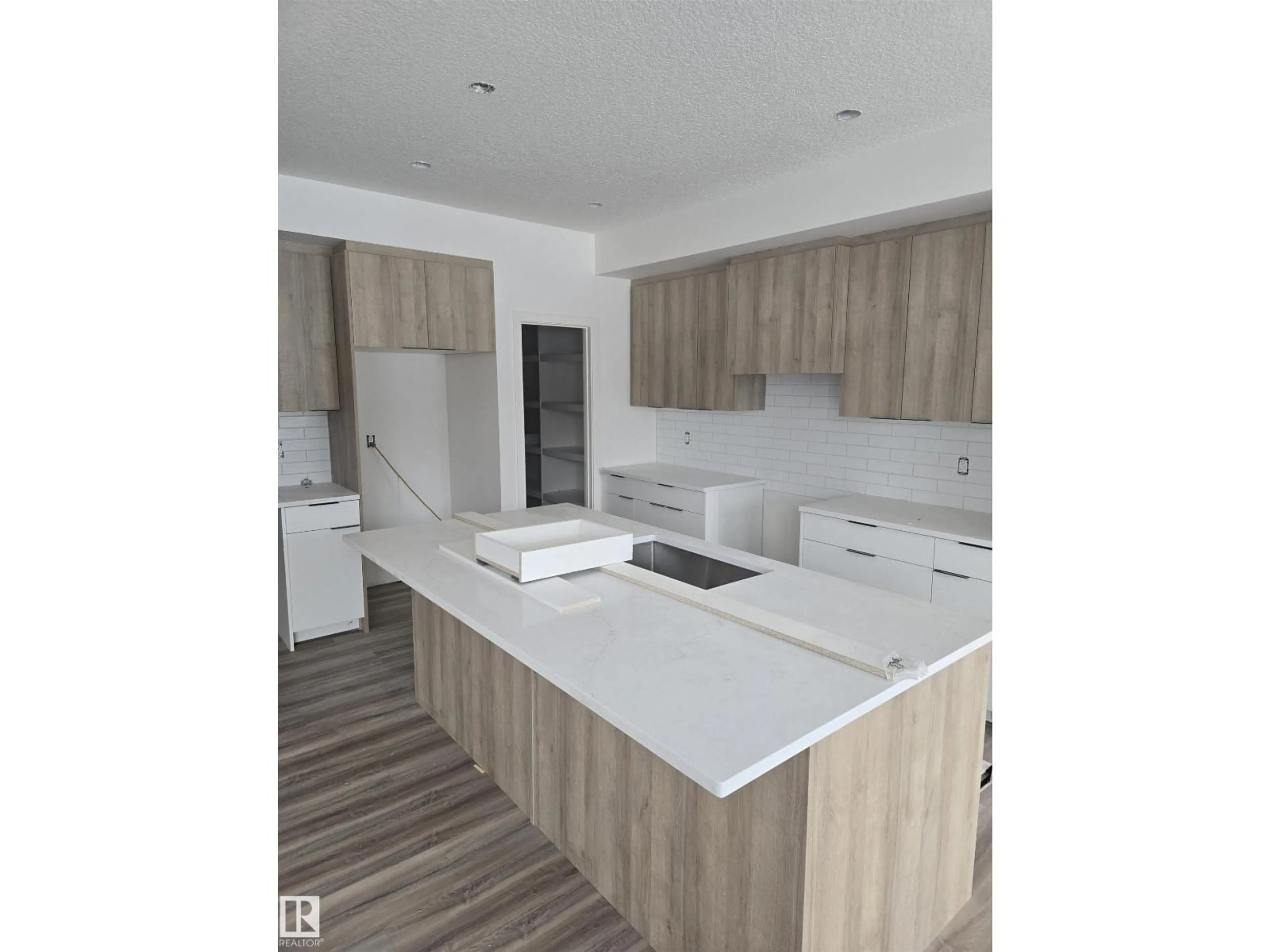 Open concept kitchen, wood/laminate floor for 7706 174A AV, Edmonton Alberta T5Z0W5
