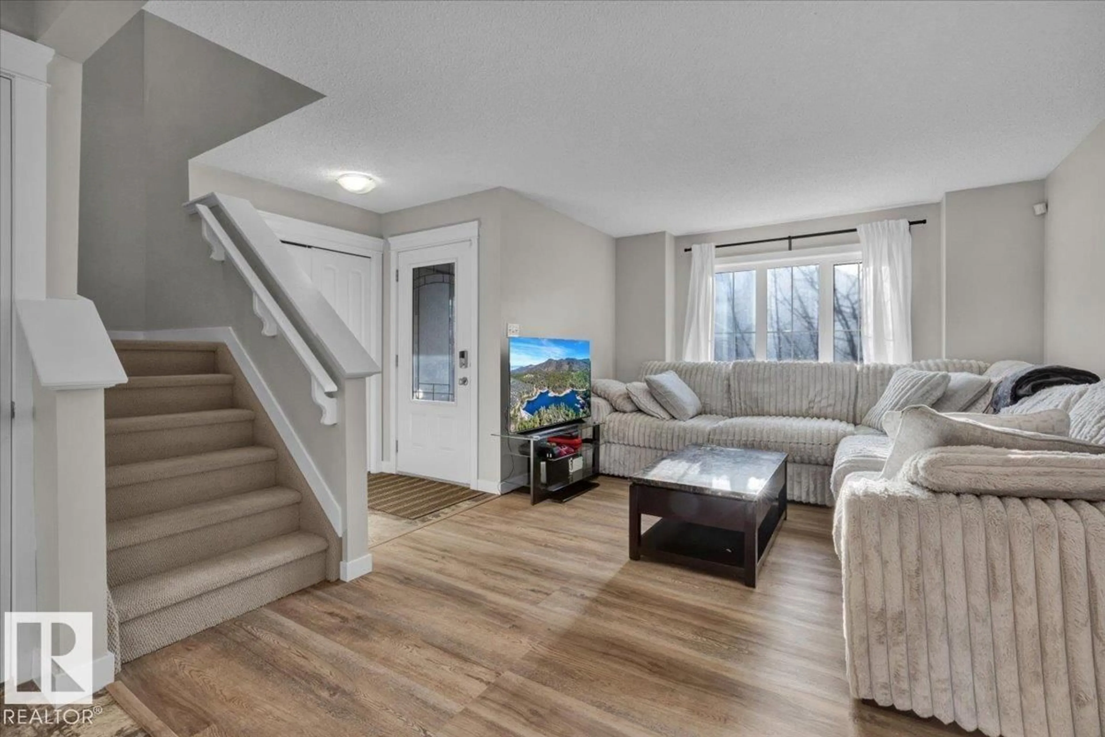 Living room with furniture, wood/laminate floor for 164 DESROCHERS GA, Edmonton Alberta T6W3H8