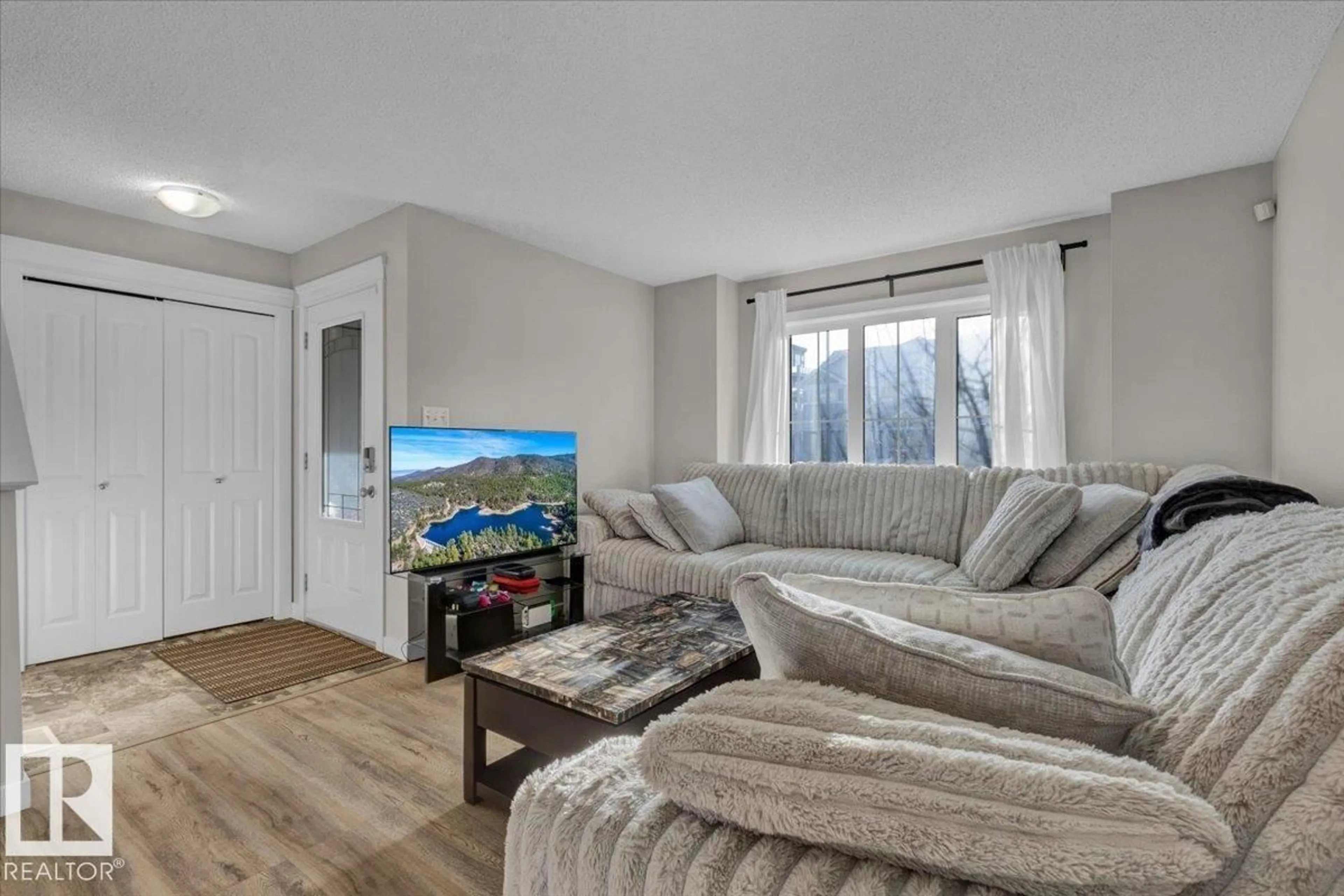 Living room with furniture, wood/laminate floor for 164 DESROCHERS GA, Edmonton Alberta T6W3H8
