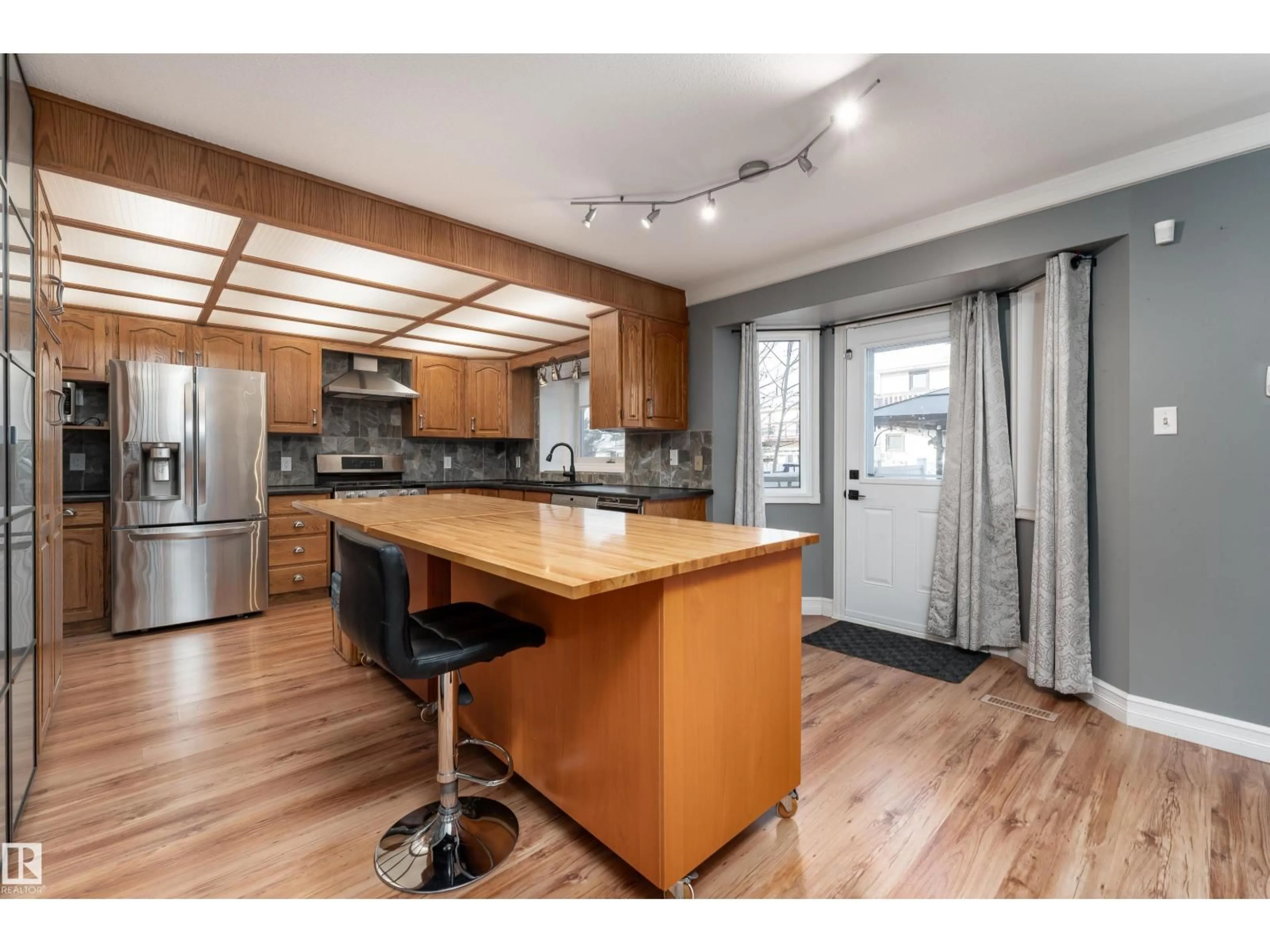 Open concept kitchen, wood/laminate floor for 16108 109 ST, Edmonton Alberta T5E3V8