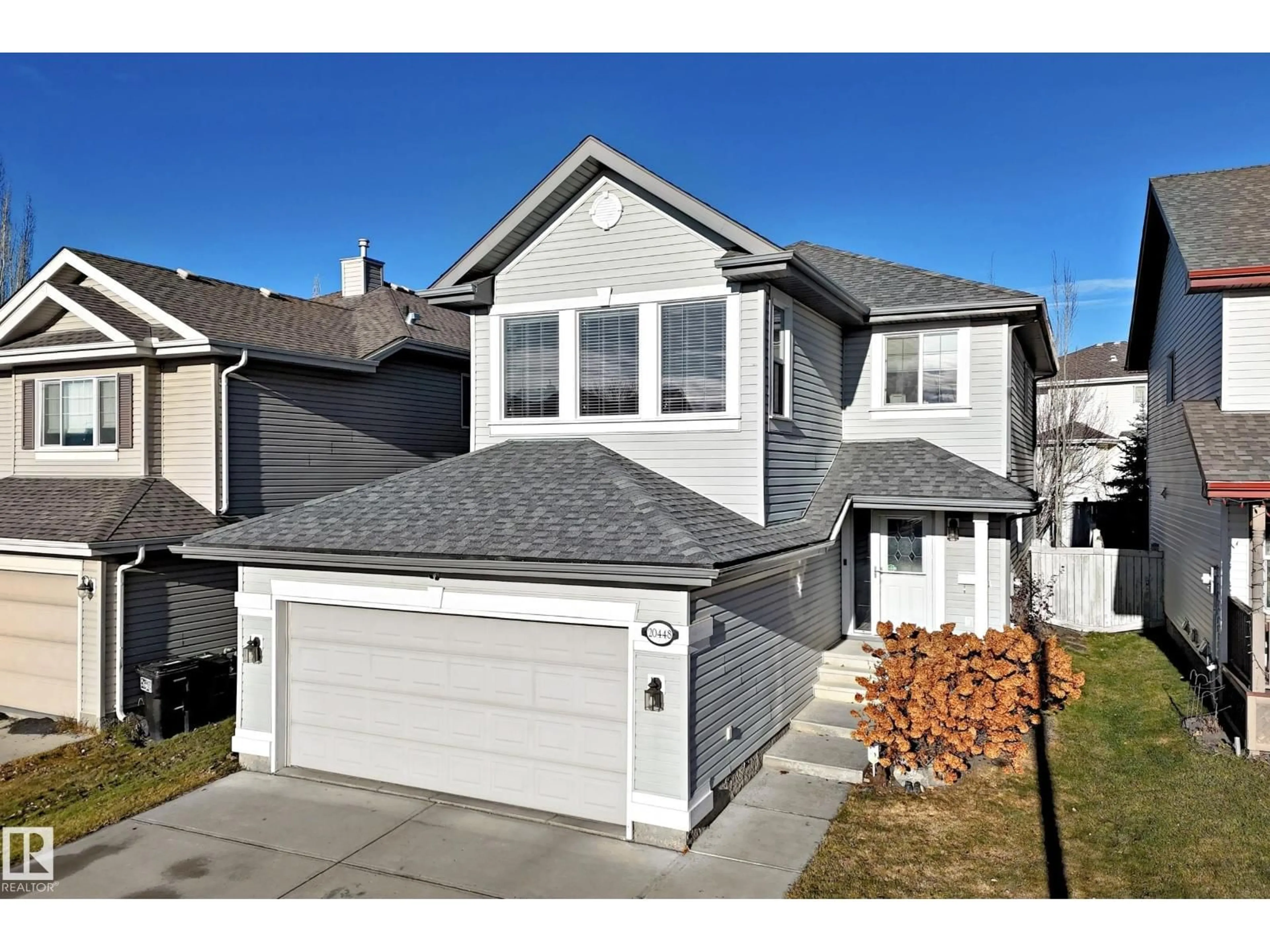 Home with vinyl exterior material, street for 20448 56 AV, Edmonton Alberta T6M0B8