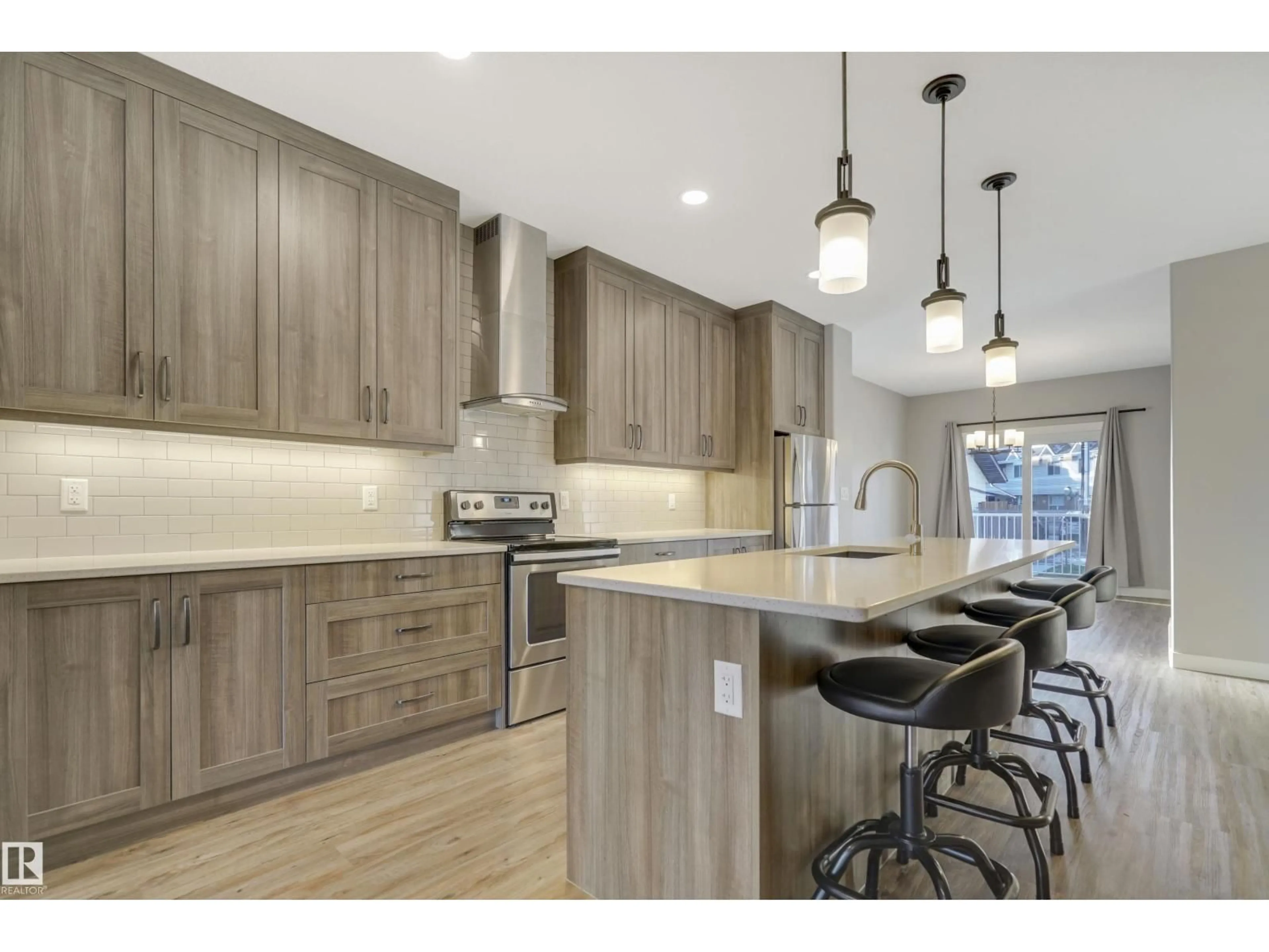 Open concept kitchen, wood/laminate floor for 8540 89 ST, Edmonton Alberta T6C3K3